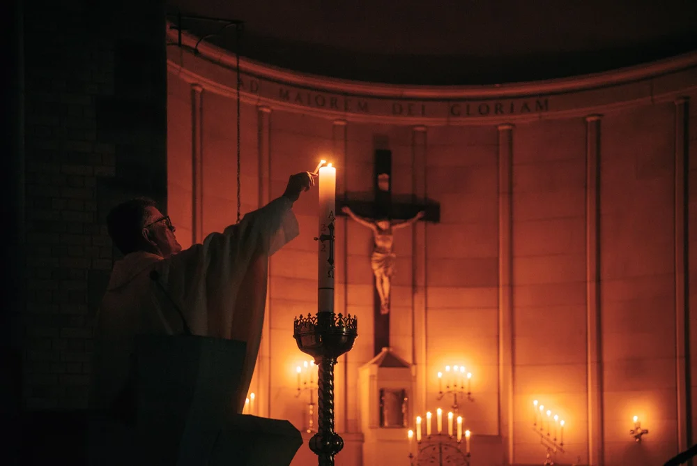 Fr Richard Leonard SJ lighting a candle at the altar
