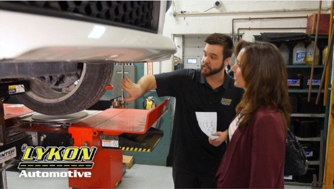 Lykon Automotive team member pointing at vehicle repair Bristol PA