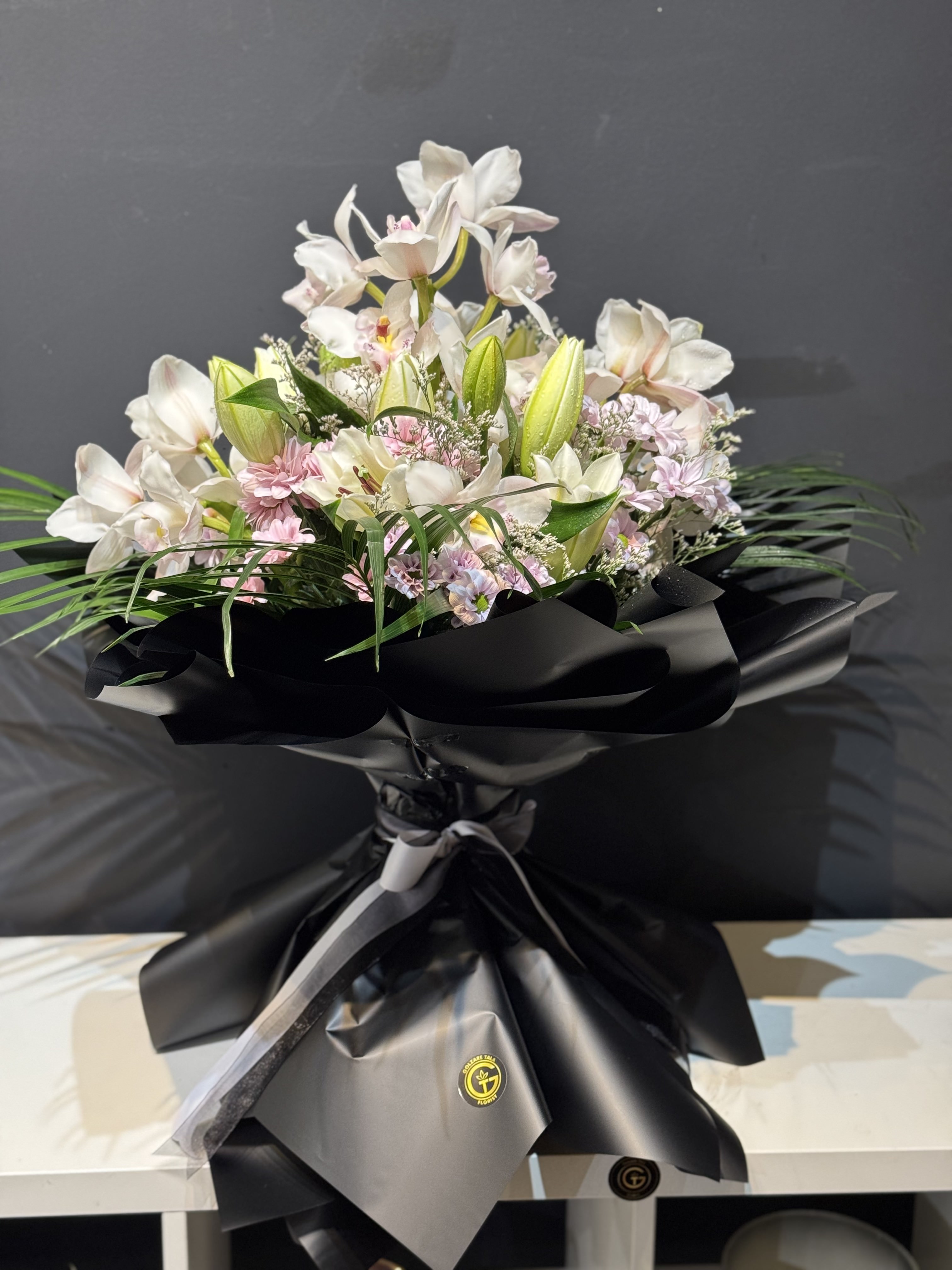 Large white lily and chrysanthemum funeral easel arrangement