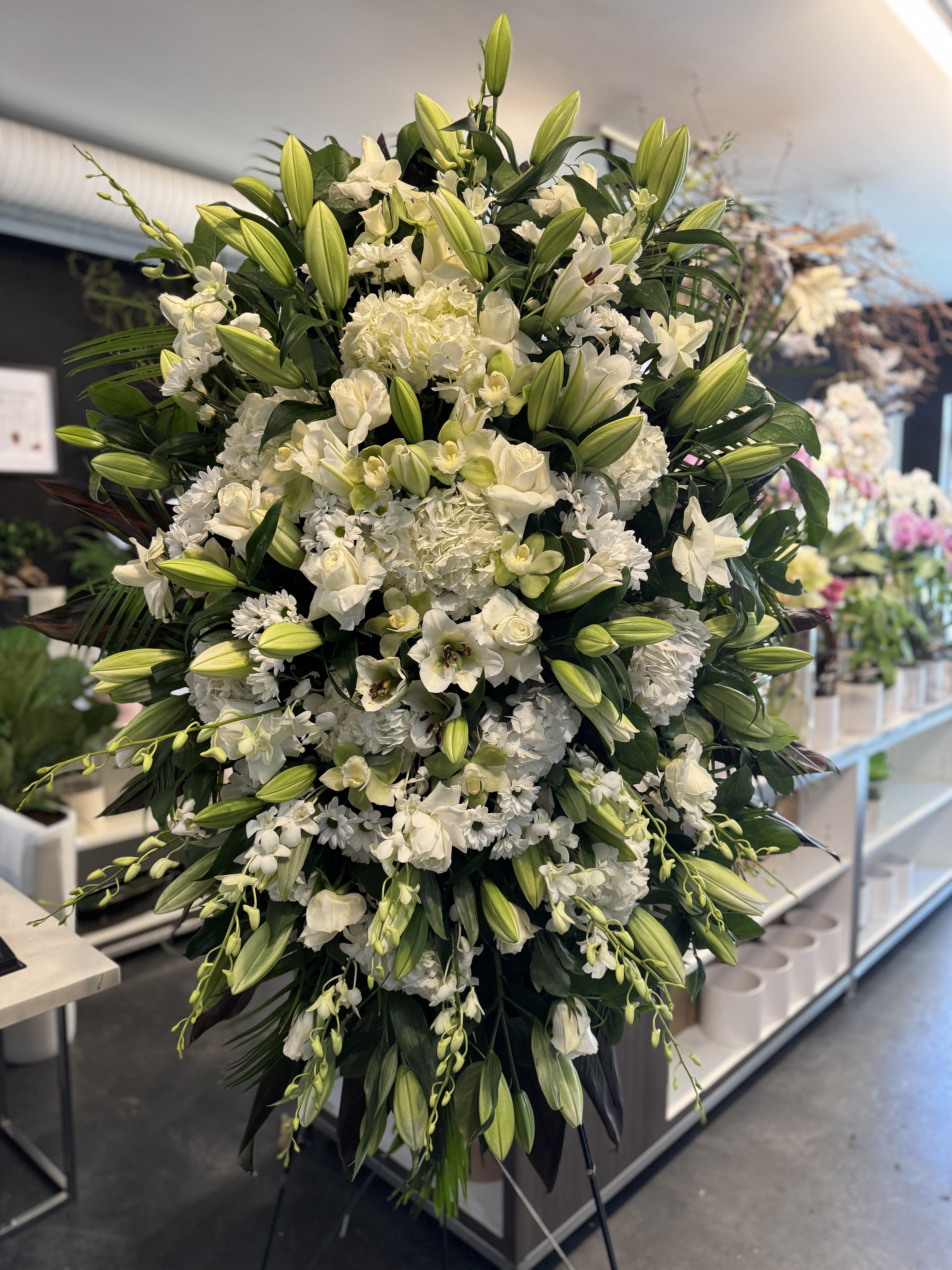 White rose and hydrangea cross tribute with satin ribbon detail