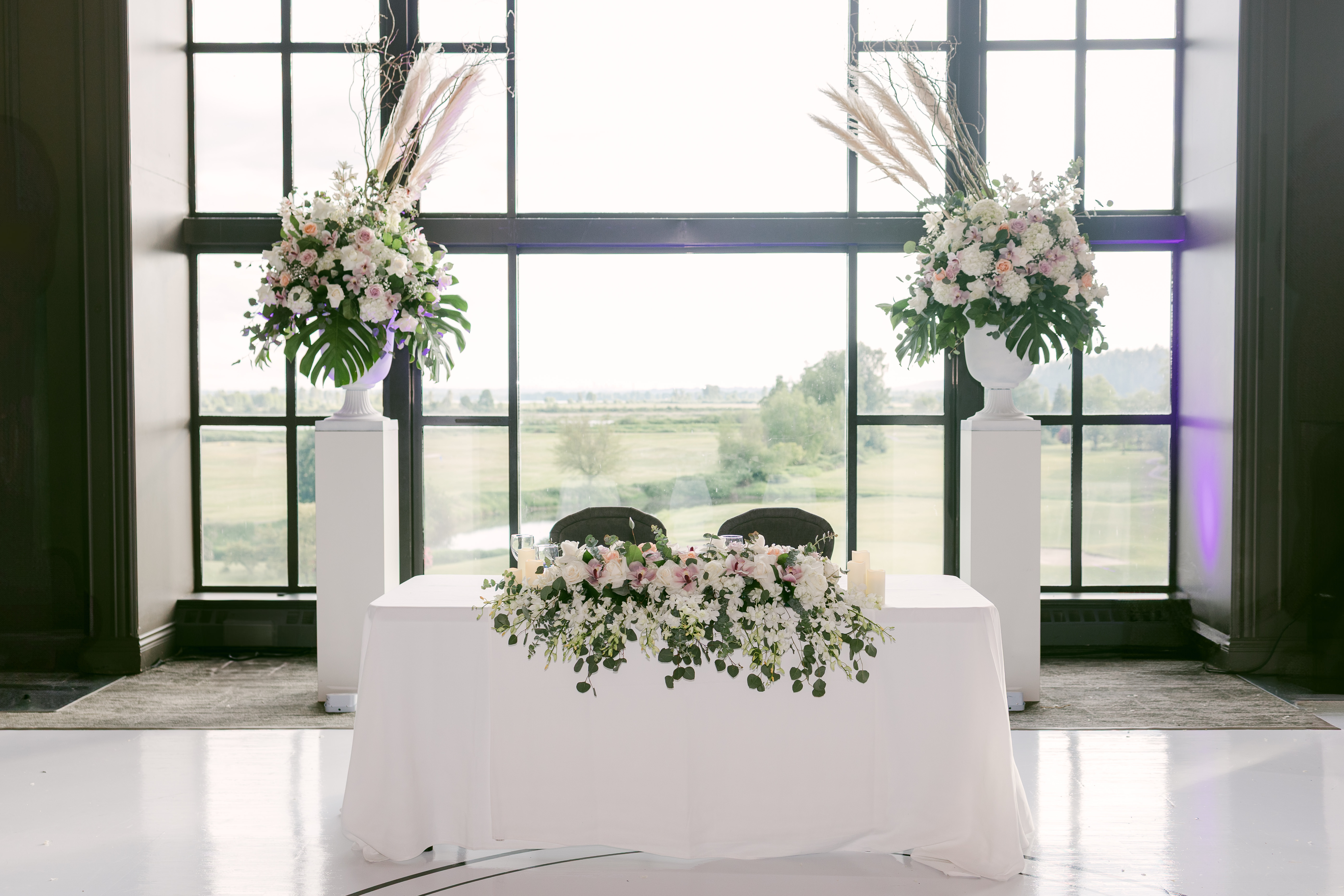 Radiant all-white bridal bouquet with phalaenopsis orchids and cascading jasmine