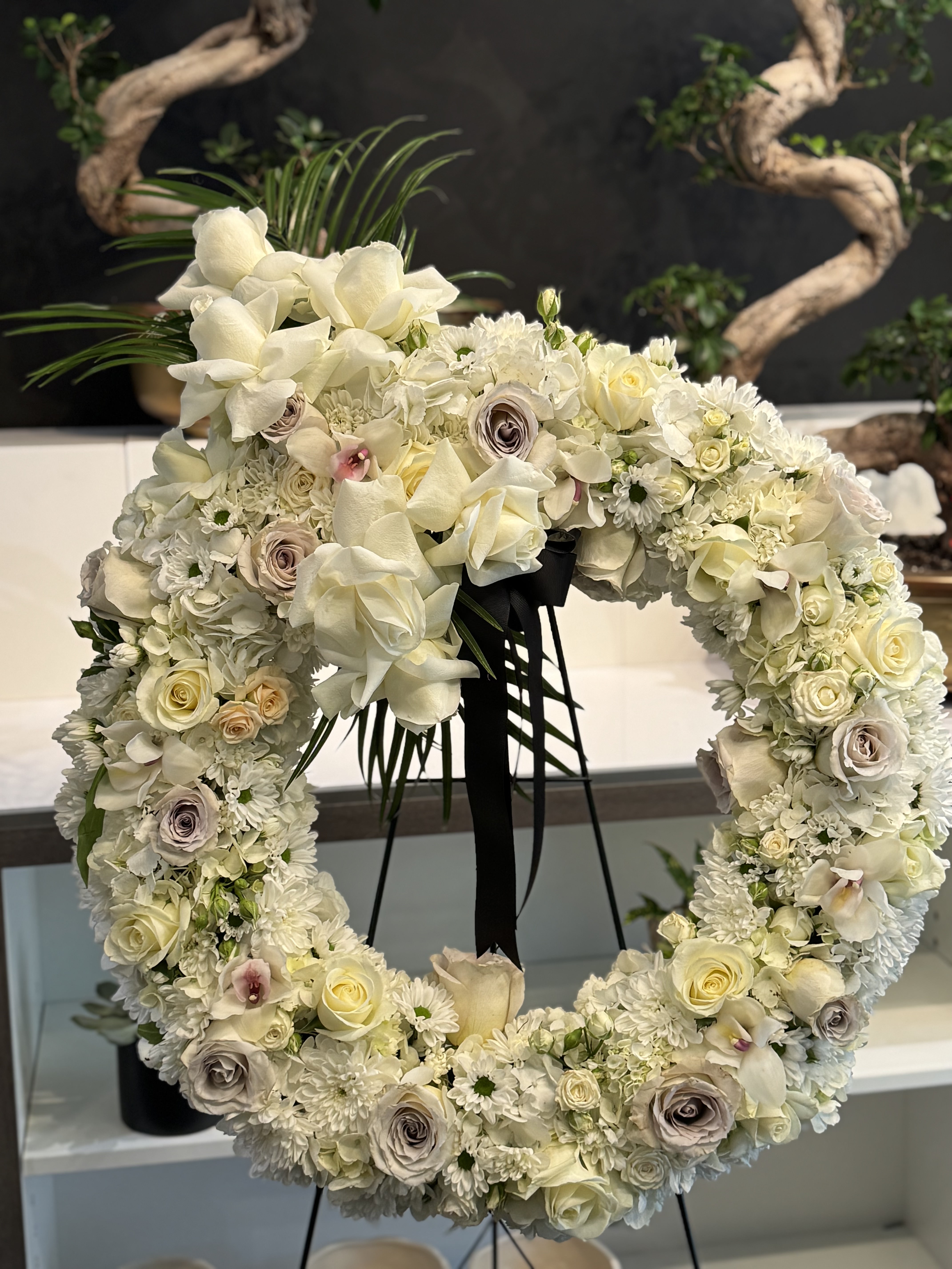 Dreamy white lisianthus and rose arrangement with delicate fern