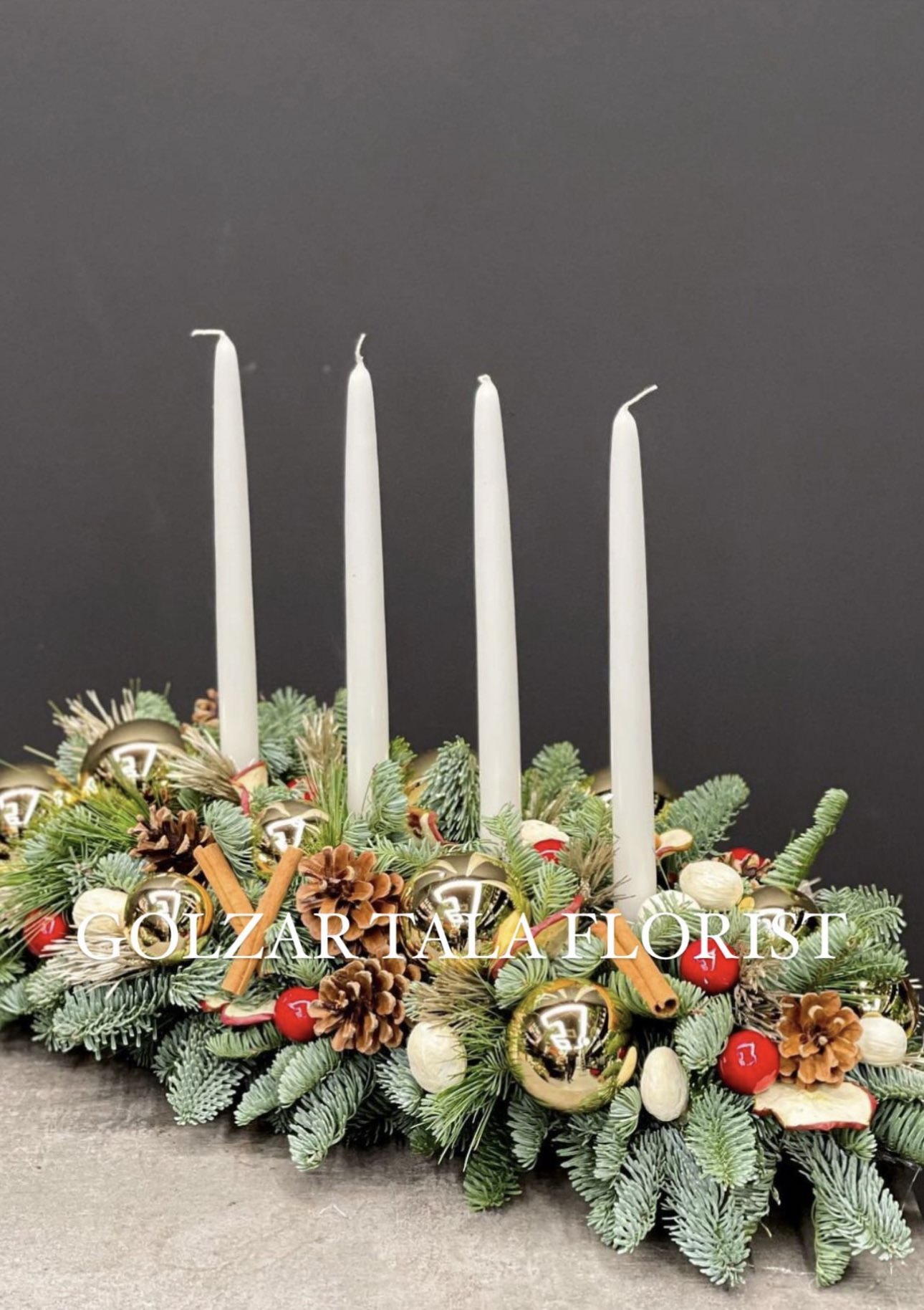 Sophisticated arrangement of evergreens and white roses with silver ribbon — refined Christmas luxury