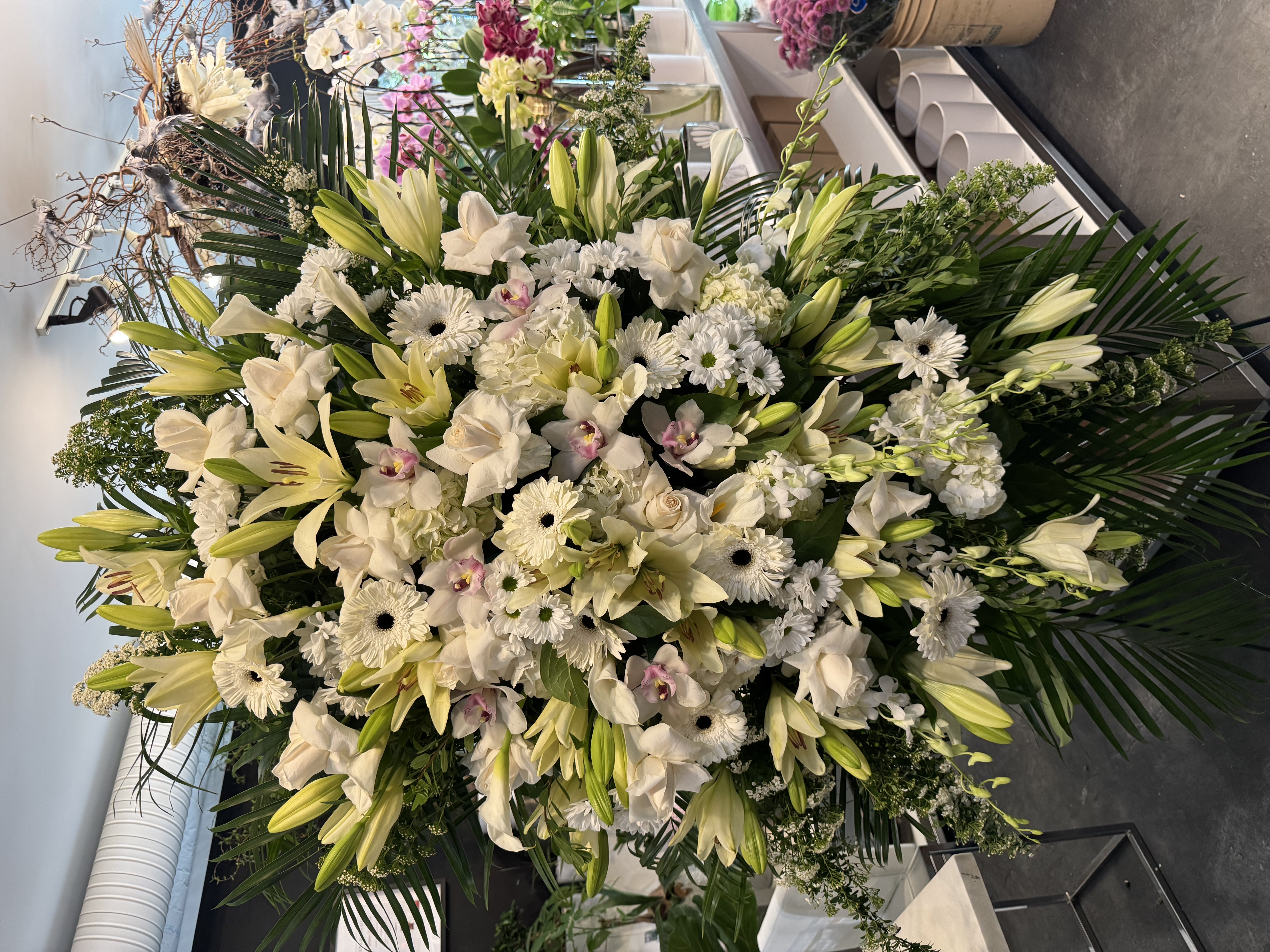 Luminous heart-shaped cascade bouquet with ivory garden roses and pearl details