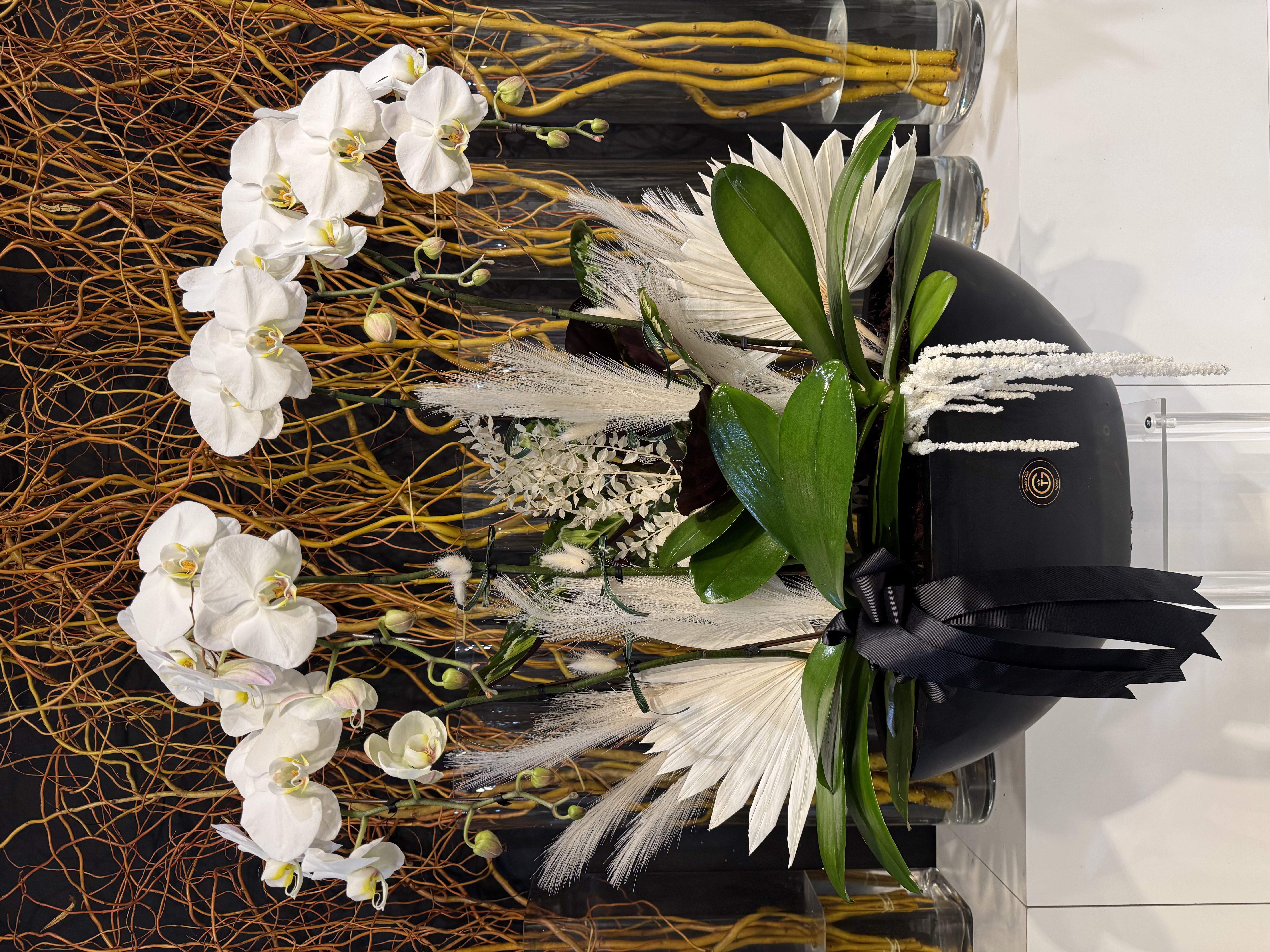 White chrysanthemum and rose basket arrangement with bow