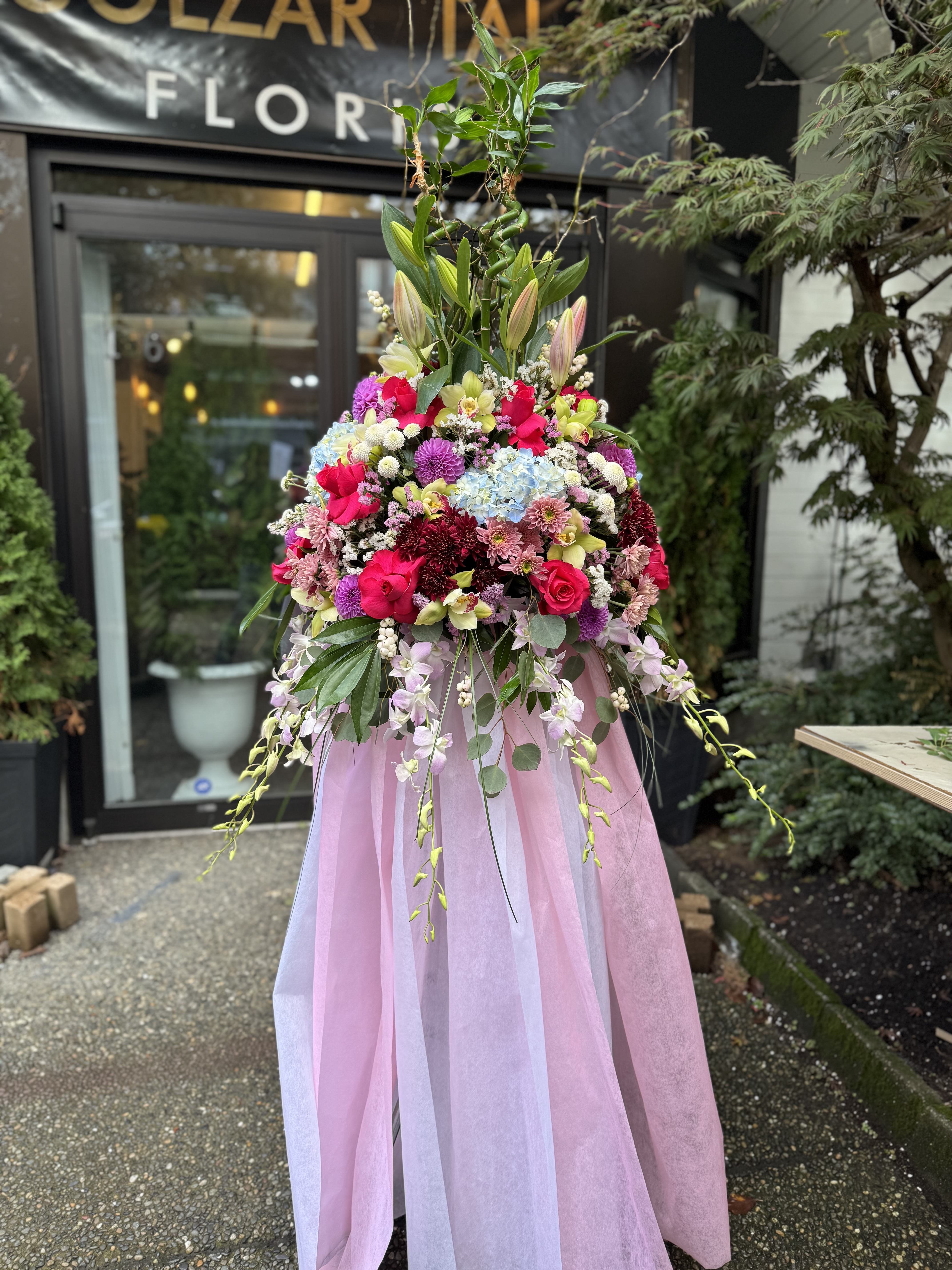 Luxurious satin-wrapped bridal bouquet with cream roses and cascading greenery