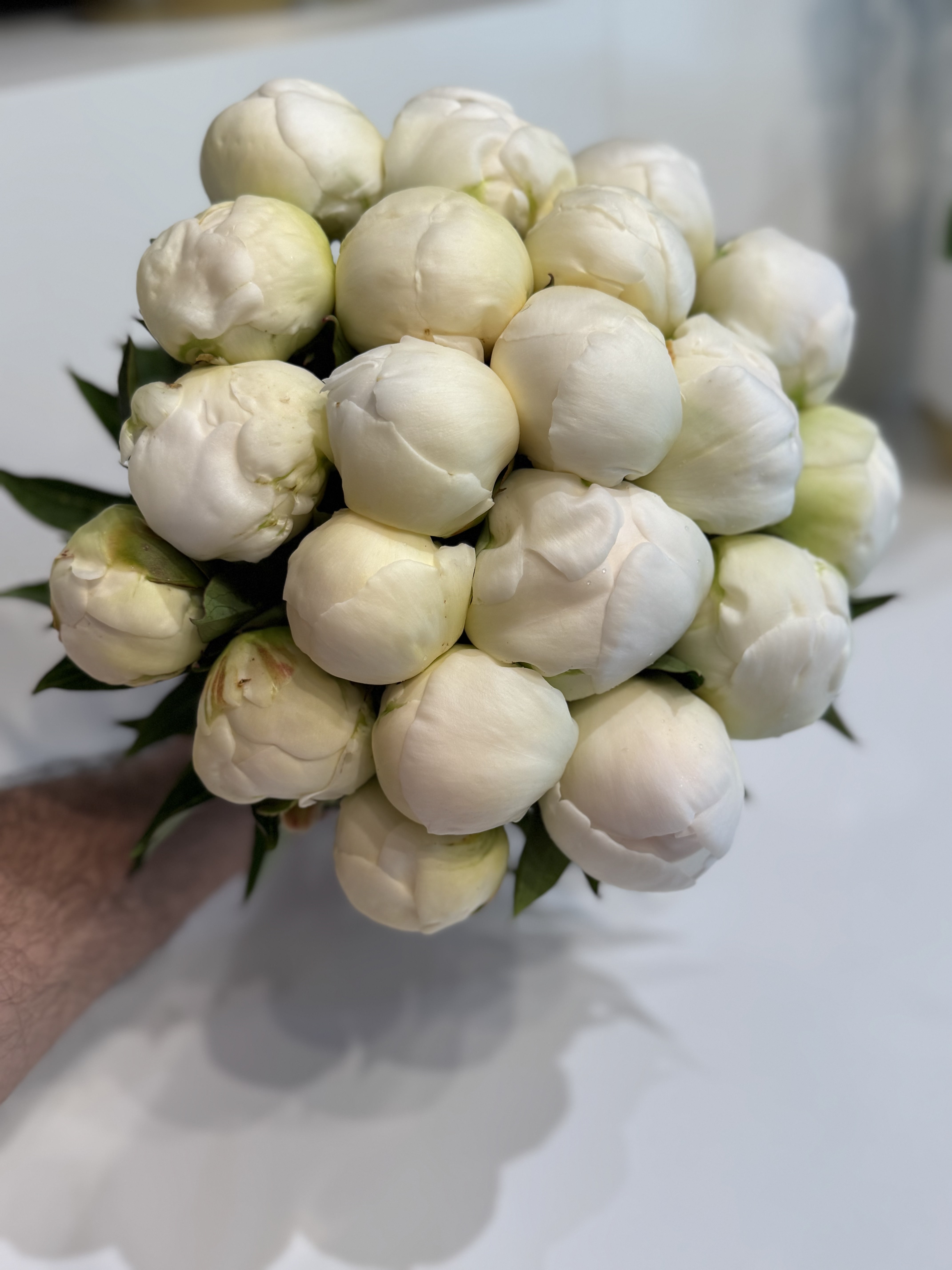 Romantic cream rose and ranunculus bridal clutch with lace detail