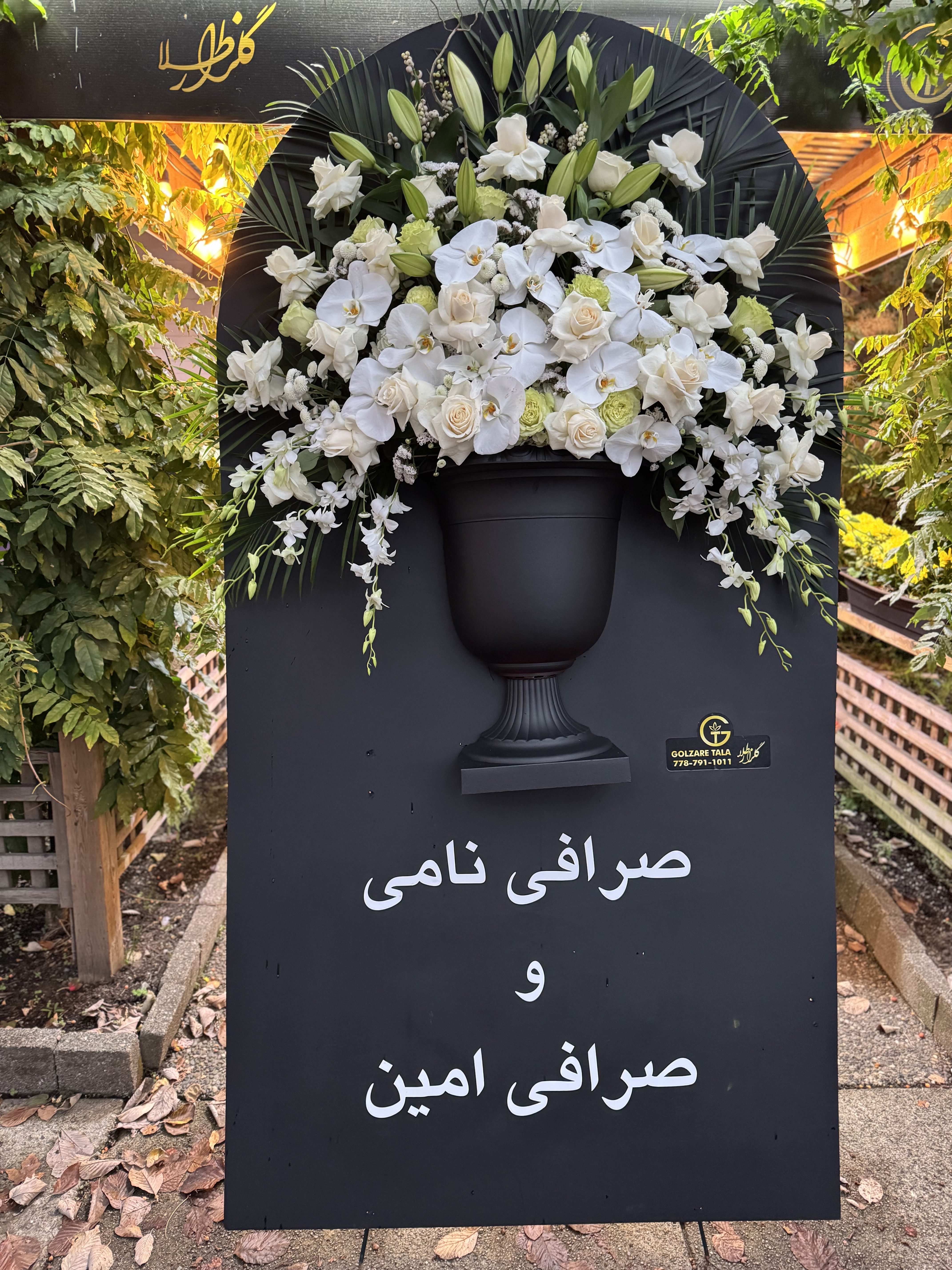 White rose and hydrangea casket cover with delicate baby breath