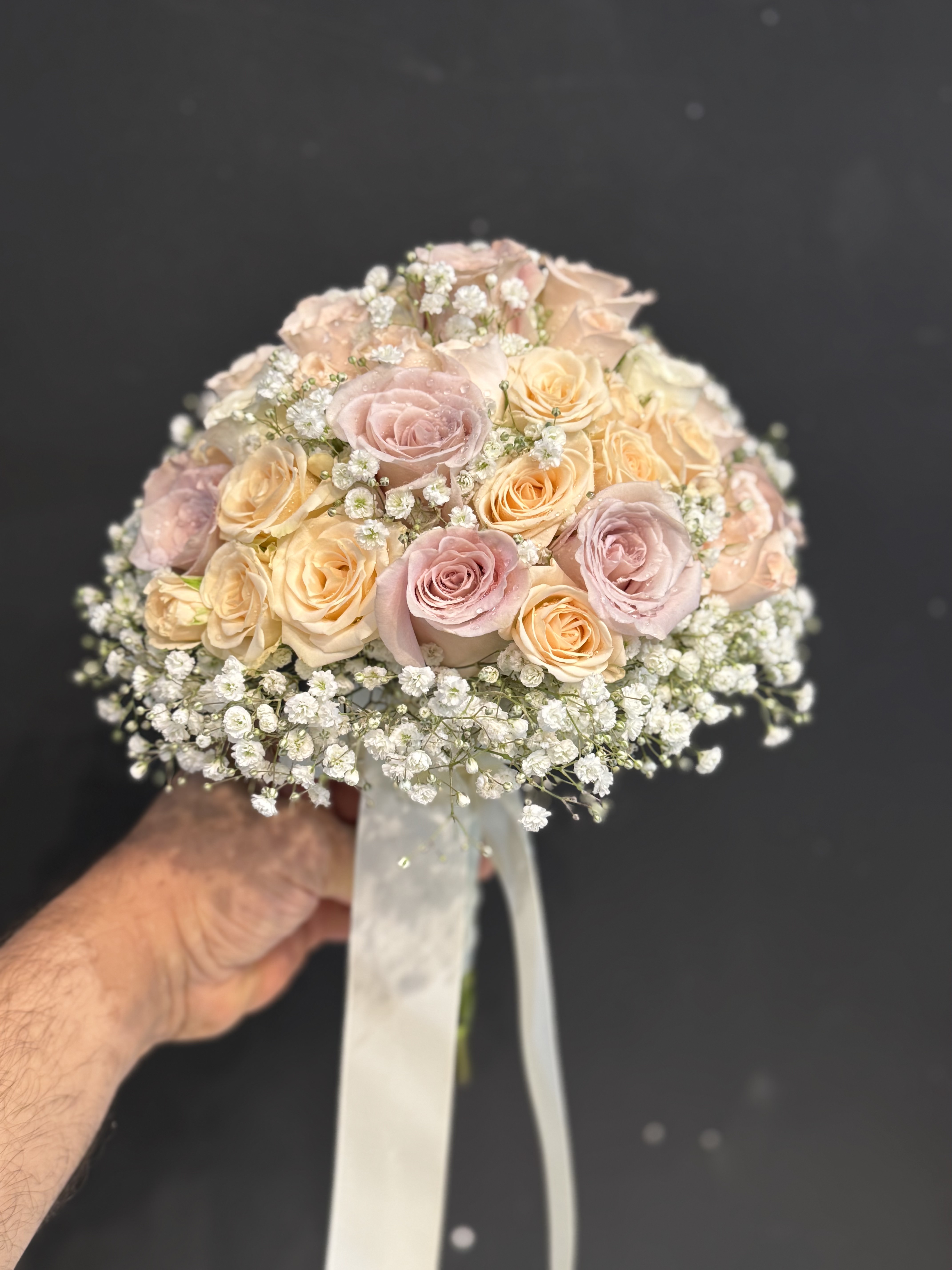 Fresh white hydrangea and rose bridal bouquet with morning dew effect