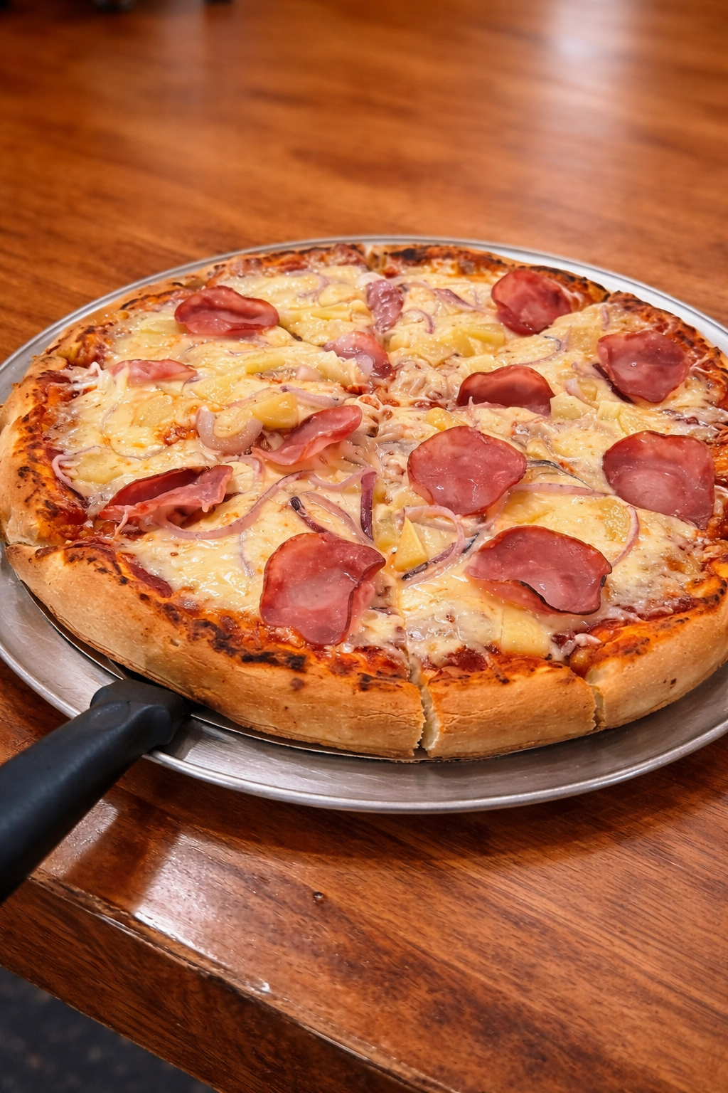 Handcrafted Hawaiian pizza with ham, pineapple, and melted cheese — made fresh in the Tipsy Tee Tavern kitchen in Adams, WI