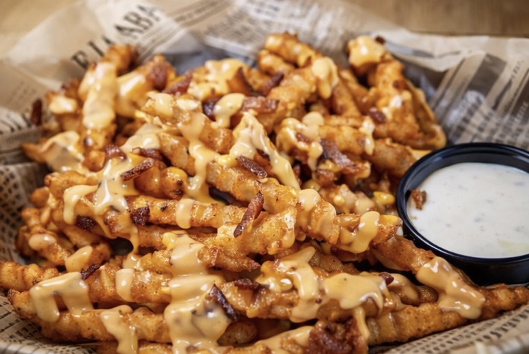 Handcrafted signature burger with loaded fries from the Tipsy Tee Tavern kitchen in Adams Wisconsin