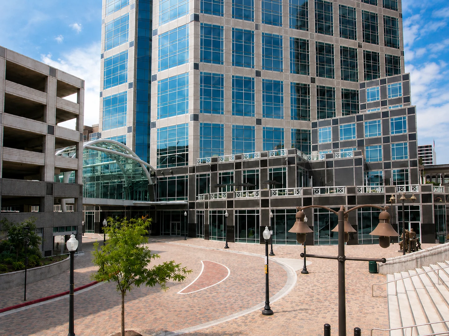 Fast Passport Center office at 299 S Main St in downtown Salt Lake City — modern glass high-rise tower with plaza and street-level entrance
