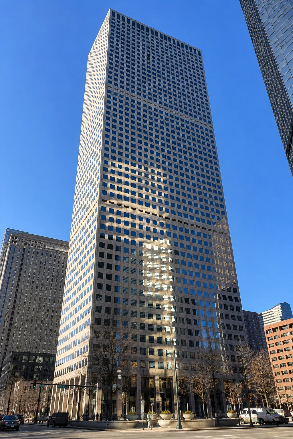 Fast Passport Center office building in downtown Denver Colorado — modern glass skyscraper at 370 17th Street with clear blue sky