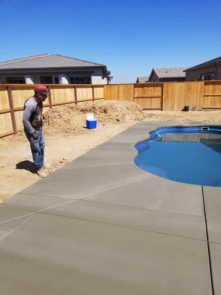 Custom shaped concrete pool deck with curved design in Ripon, CA