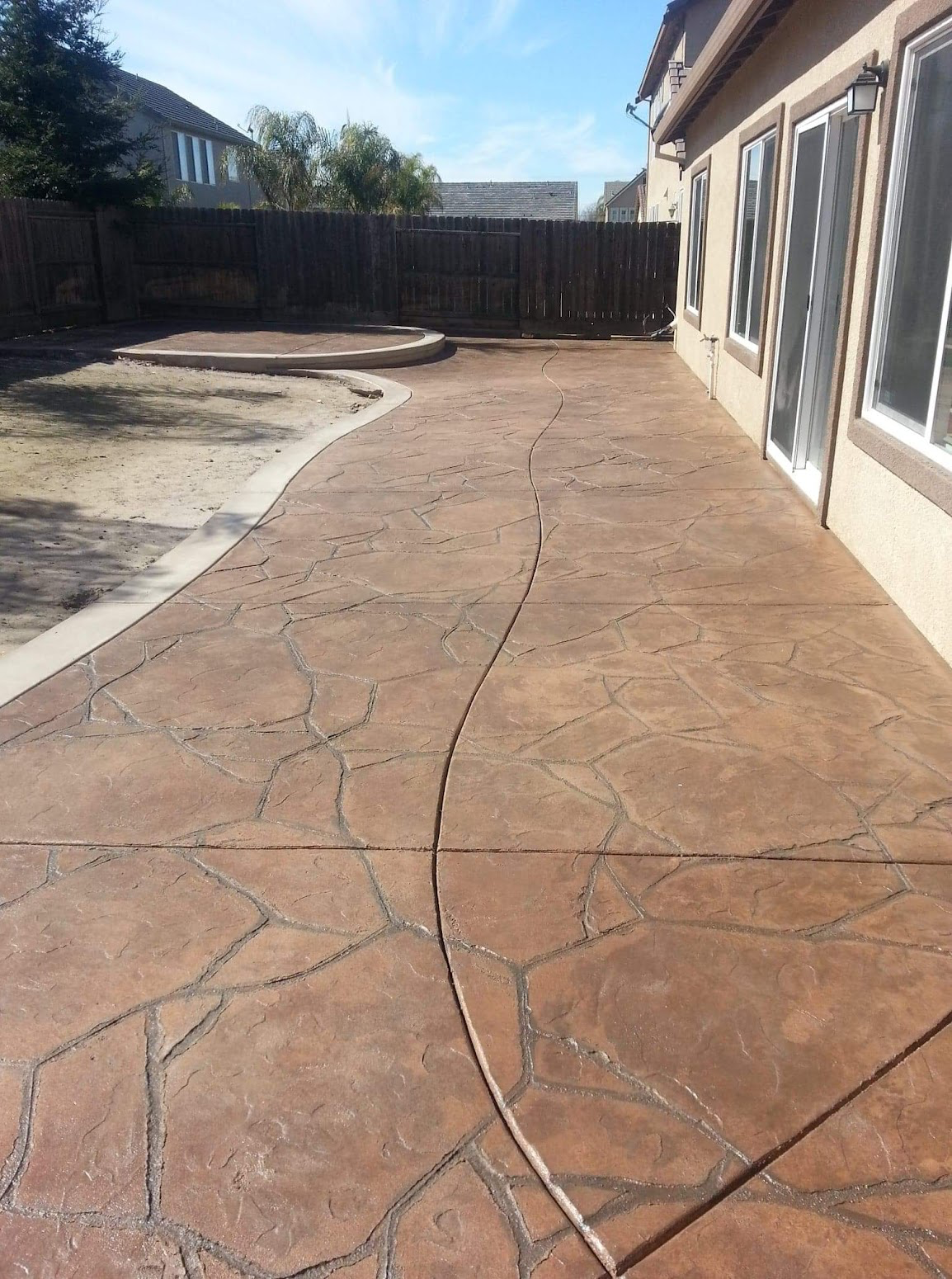 Rich brown stamped concrete patio with stone pattern in Manteca, CA