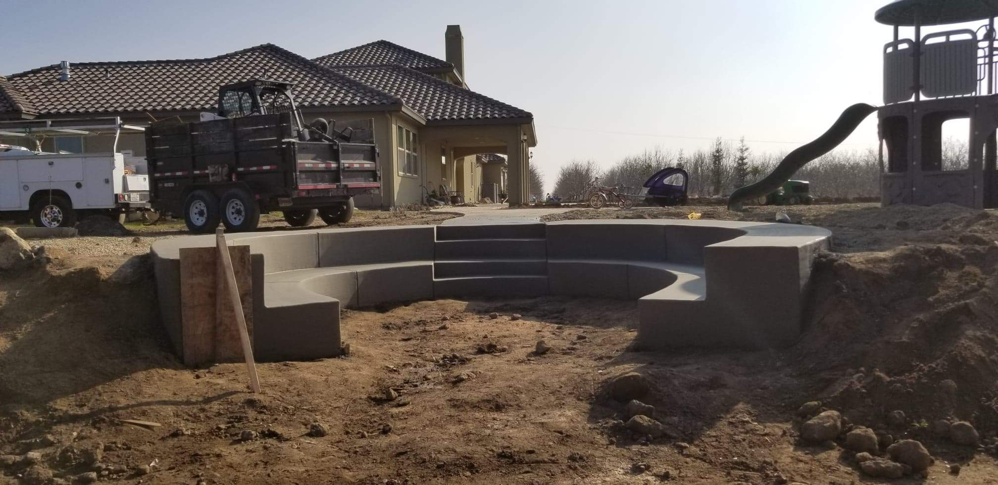 Custom curved retaining wall with steps in Stockton backyard