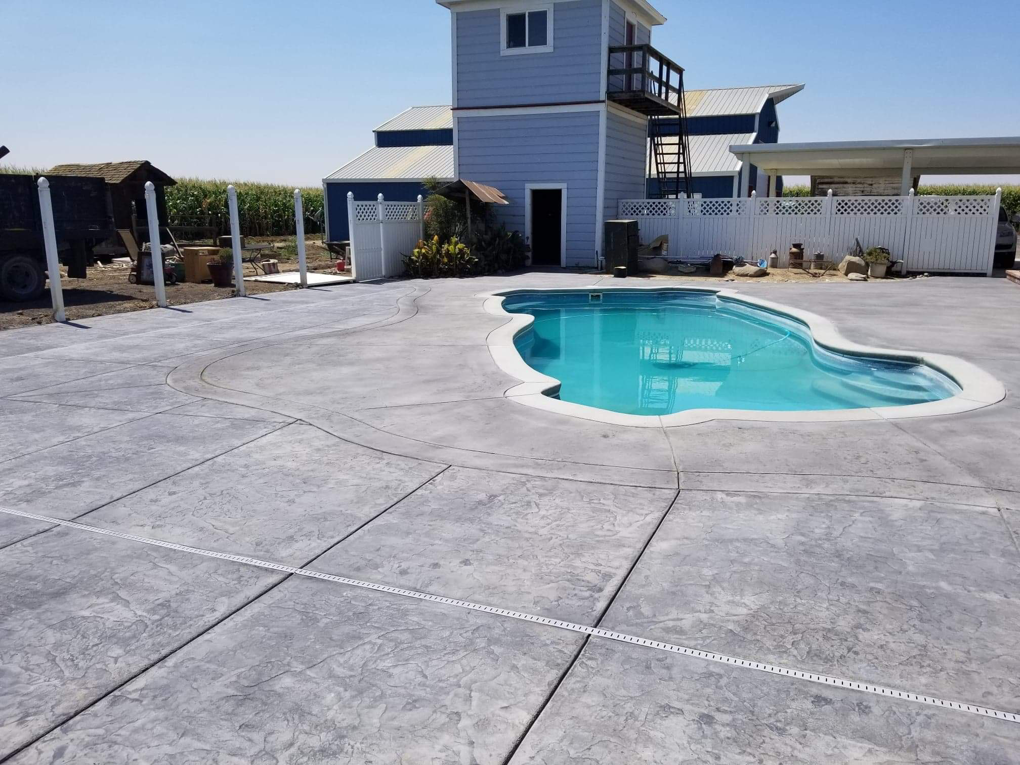 Stamped concrete pool deck with textured pattern in Modesto, CA