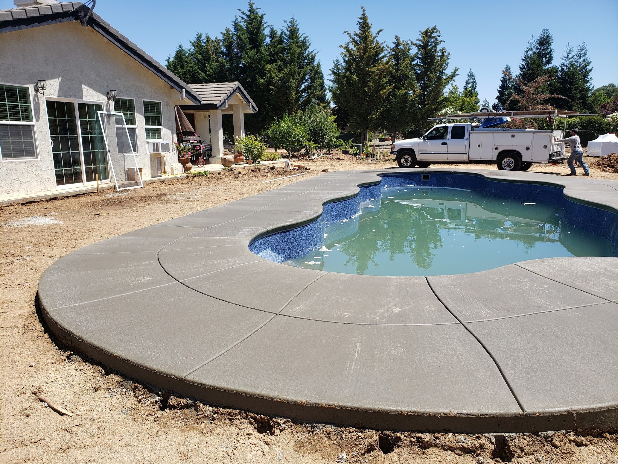 Decorative concrete pool deck with custom shape in Manteca, CA