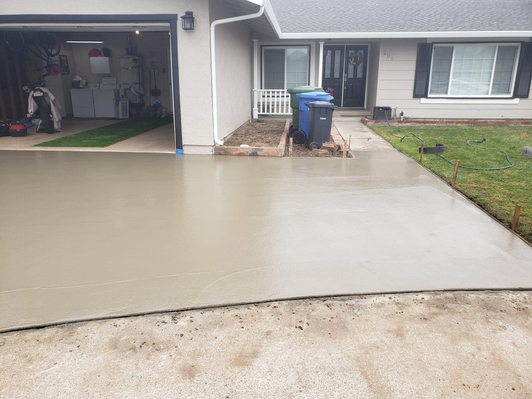 Newly poured concrete driveway in front of a home in Modesto, CA