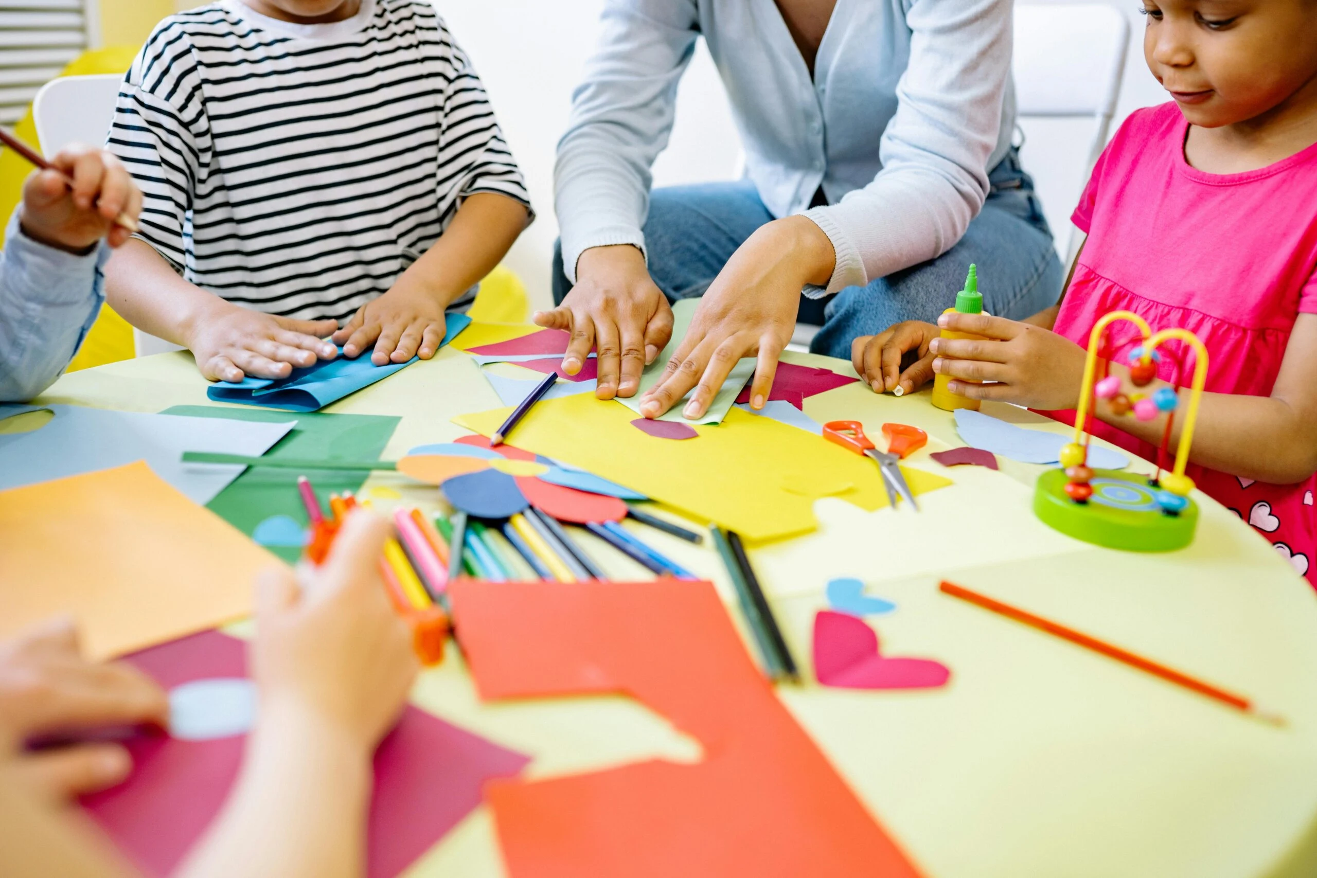 Children and teacher doing creative arts and crafts together