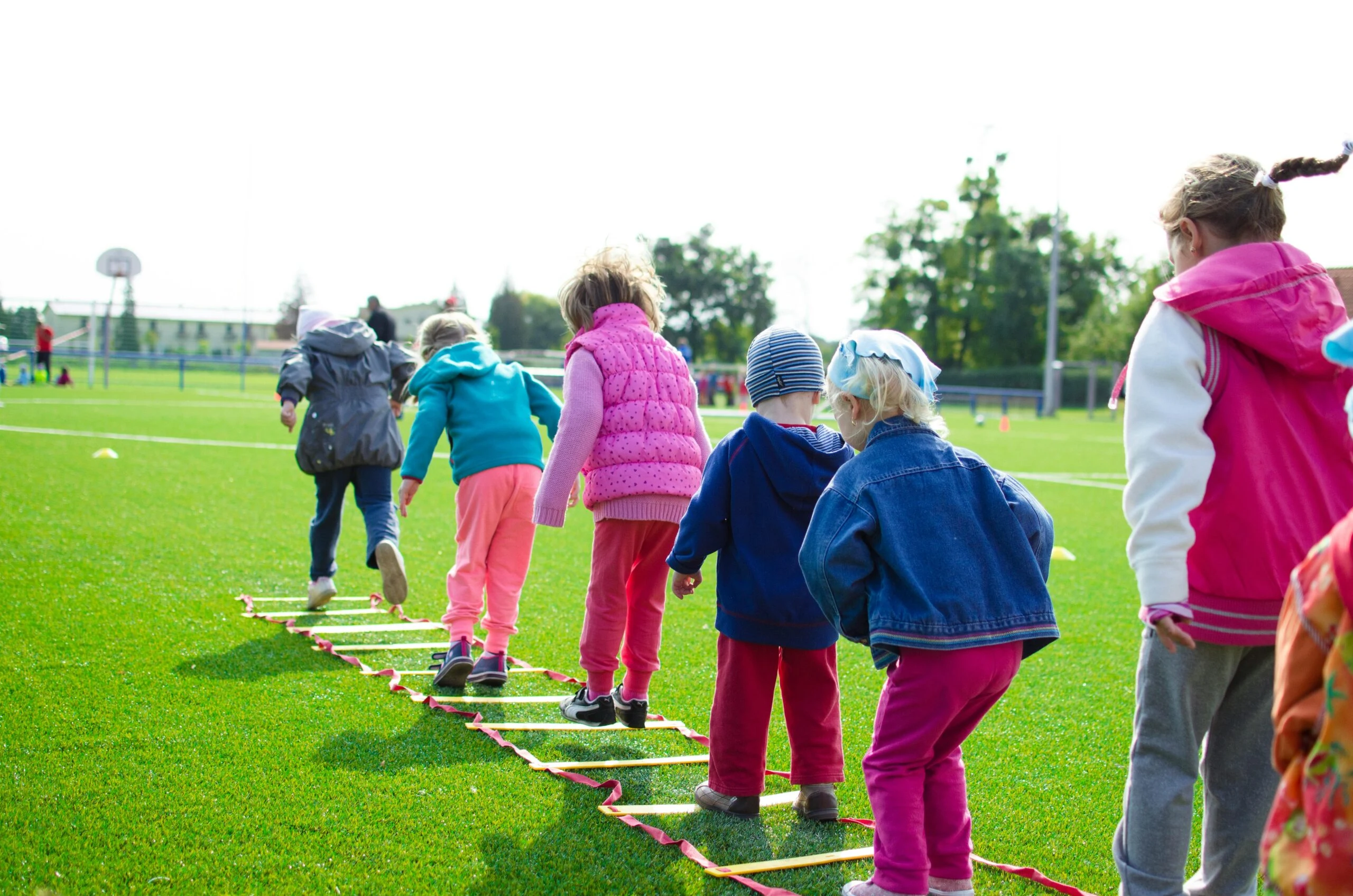 Children taking part in outdoor activities on a grassy field