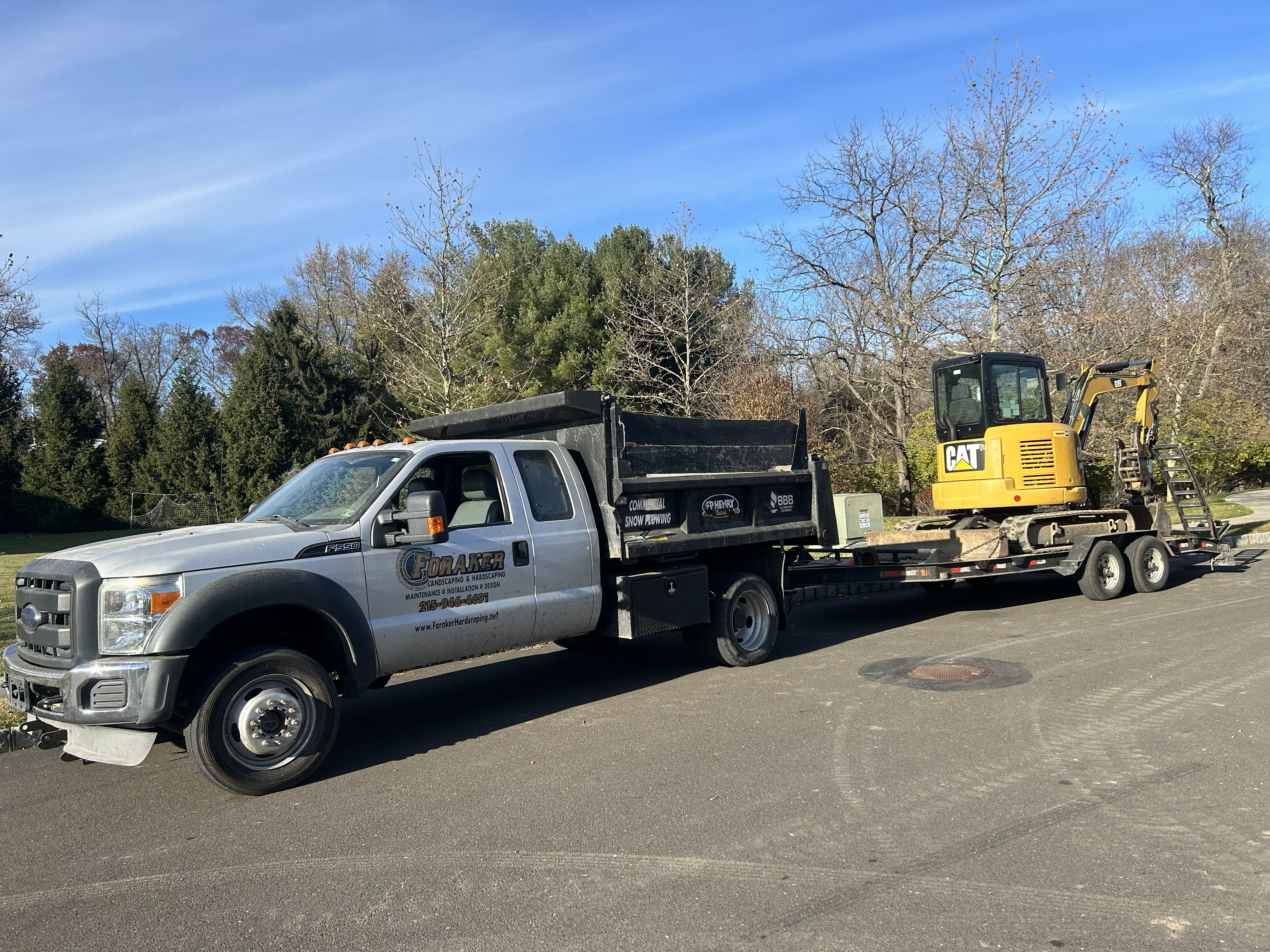 Foraker Landscaping bulk materials delivery truck unloading mulch at Bucks County PA residential property