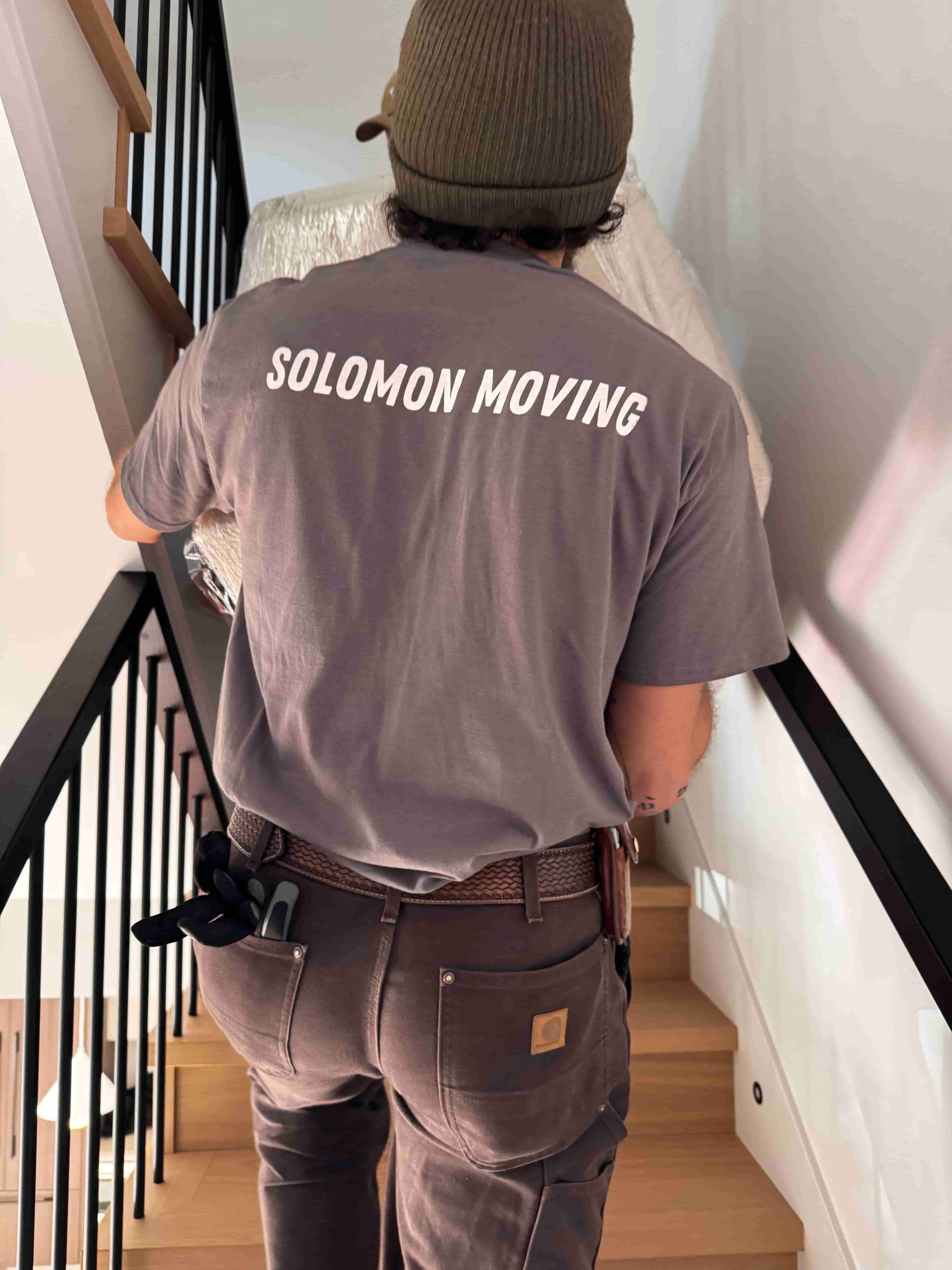 Professional caring movers with positive energy on moving day