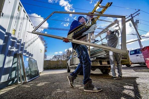 Miami glazier installing replacement glass in existing residential window frame