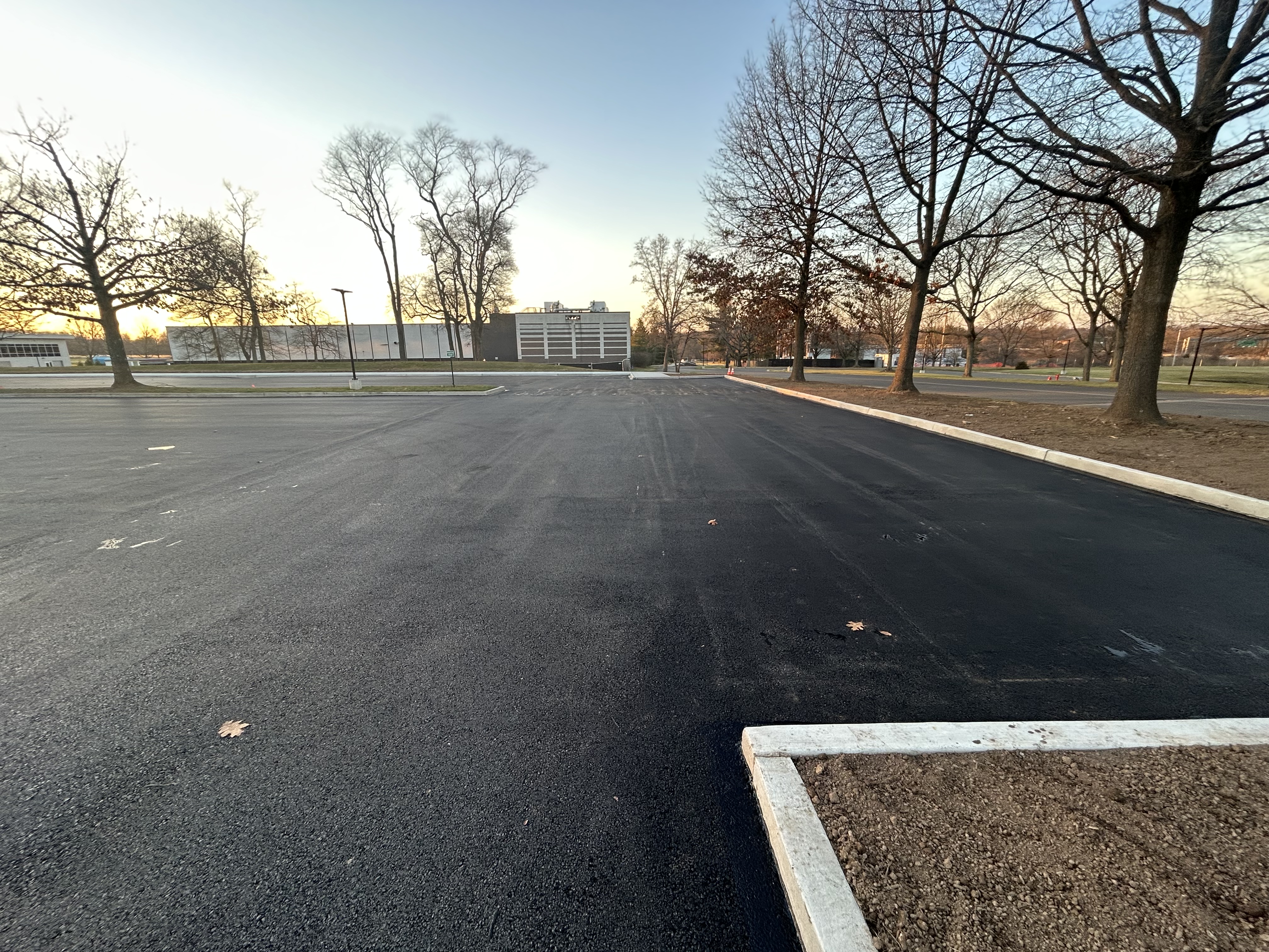 Commercial asphalt paving progress on large industrial lot
