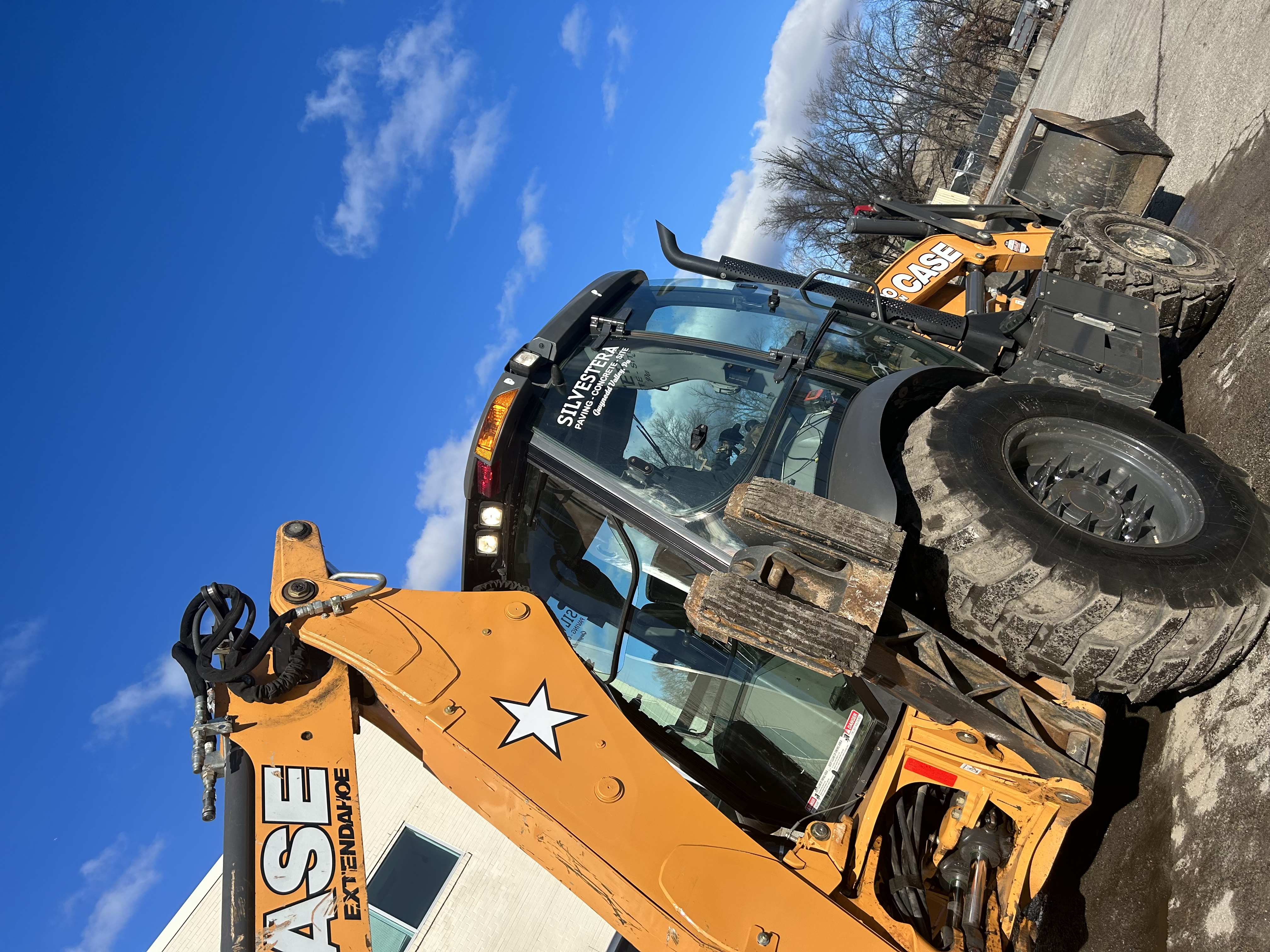 Heavy roller compacting commercial asphalt paving project