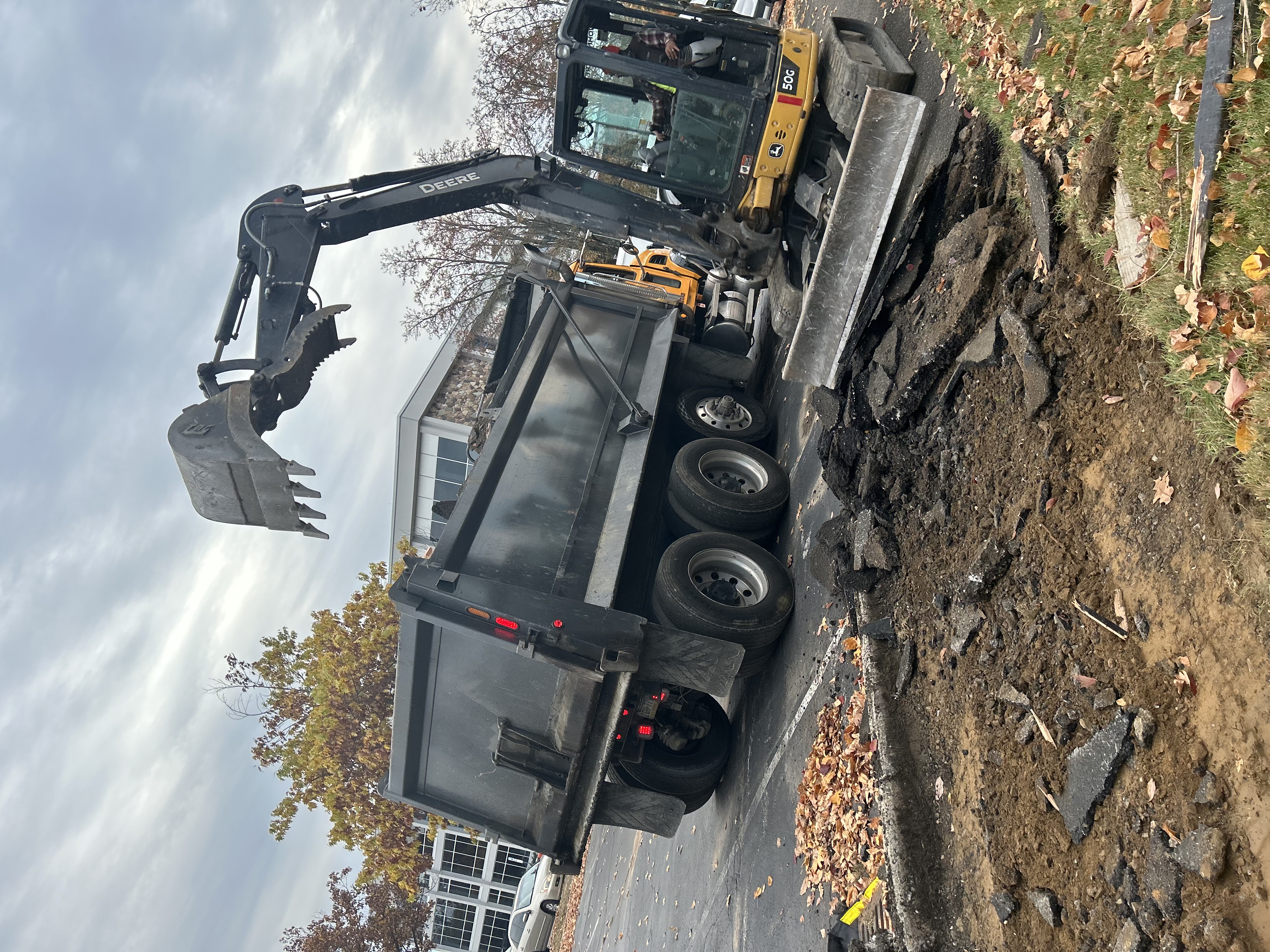 Commercial site preparation with heavy grading equipment establishing proper drainage slope and base elevation in Pennsylvania