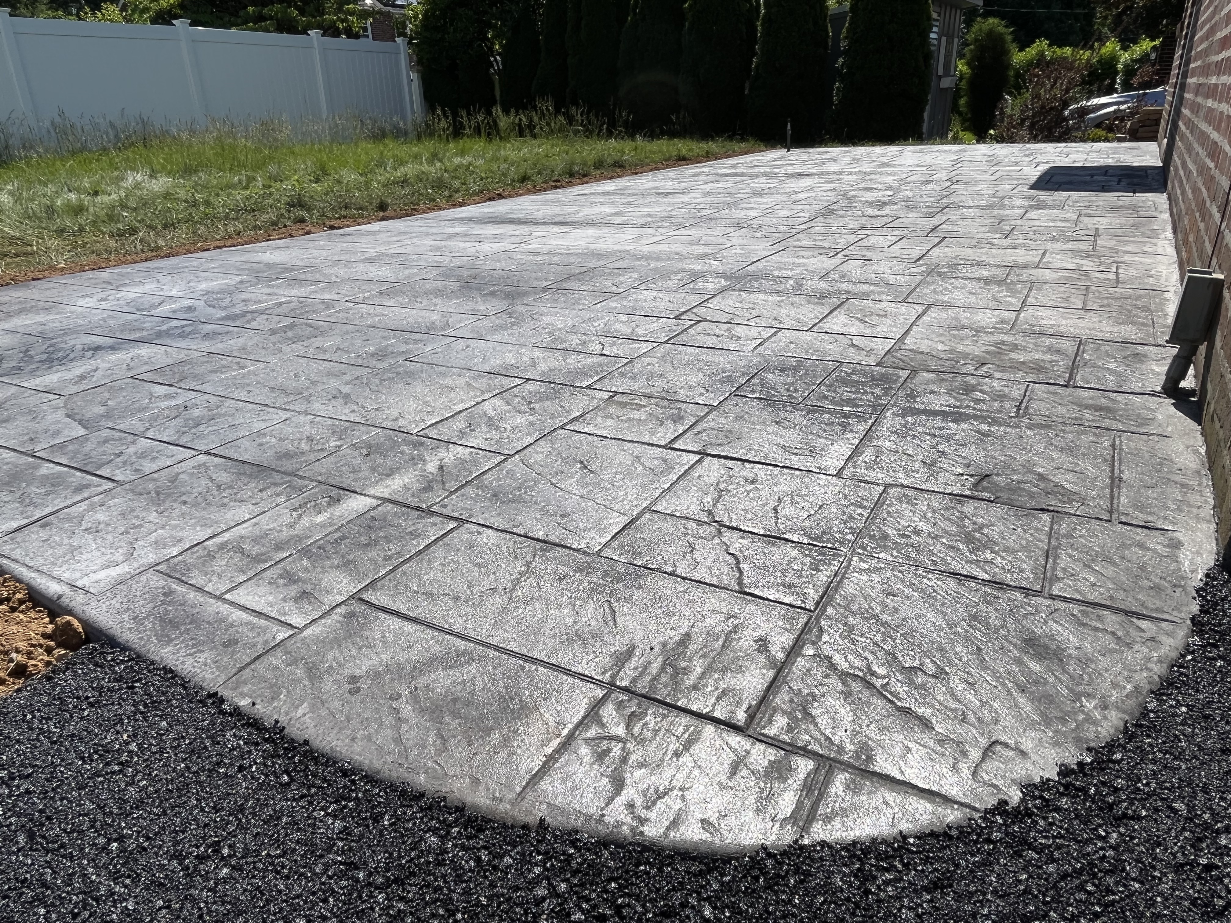 Residential stamped concrete entrance walkway with ashlar pattern