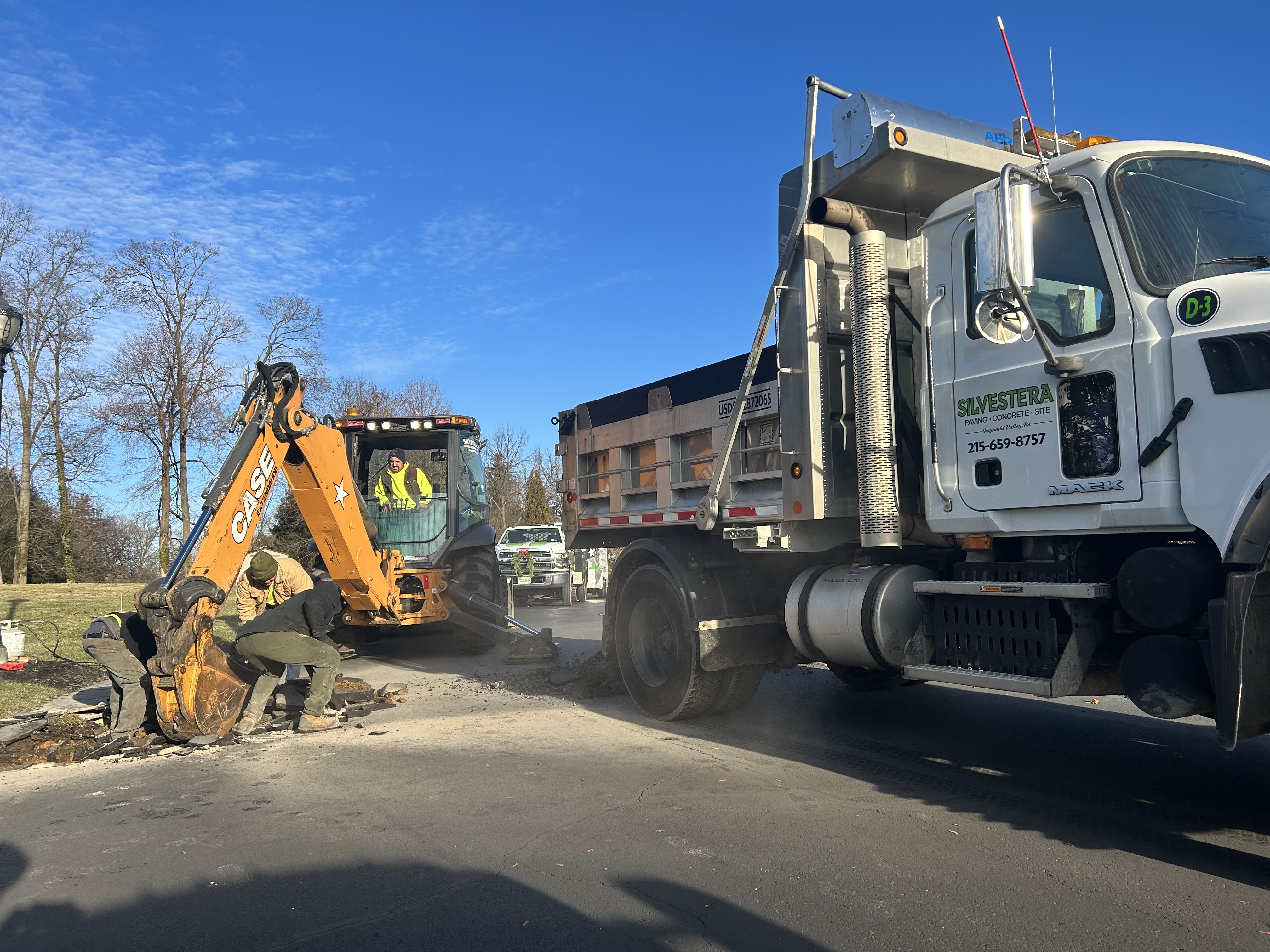 Excavator trenching for drainage installation on a development site