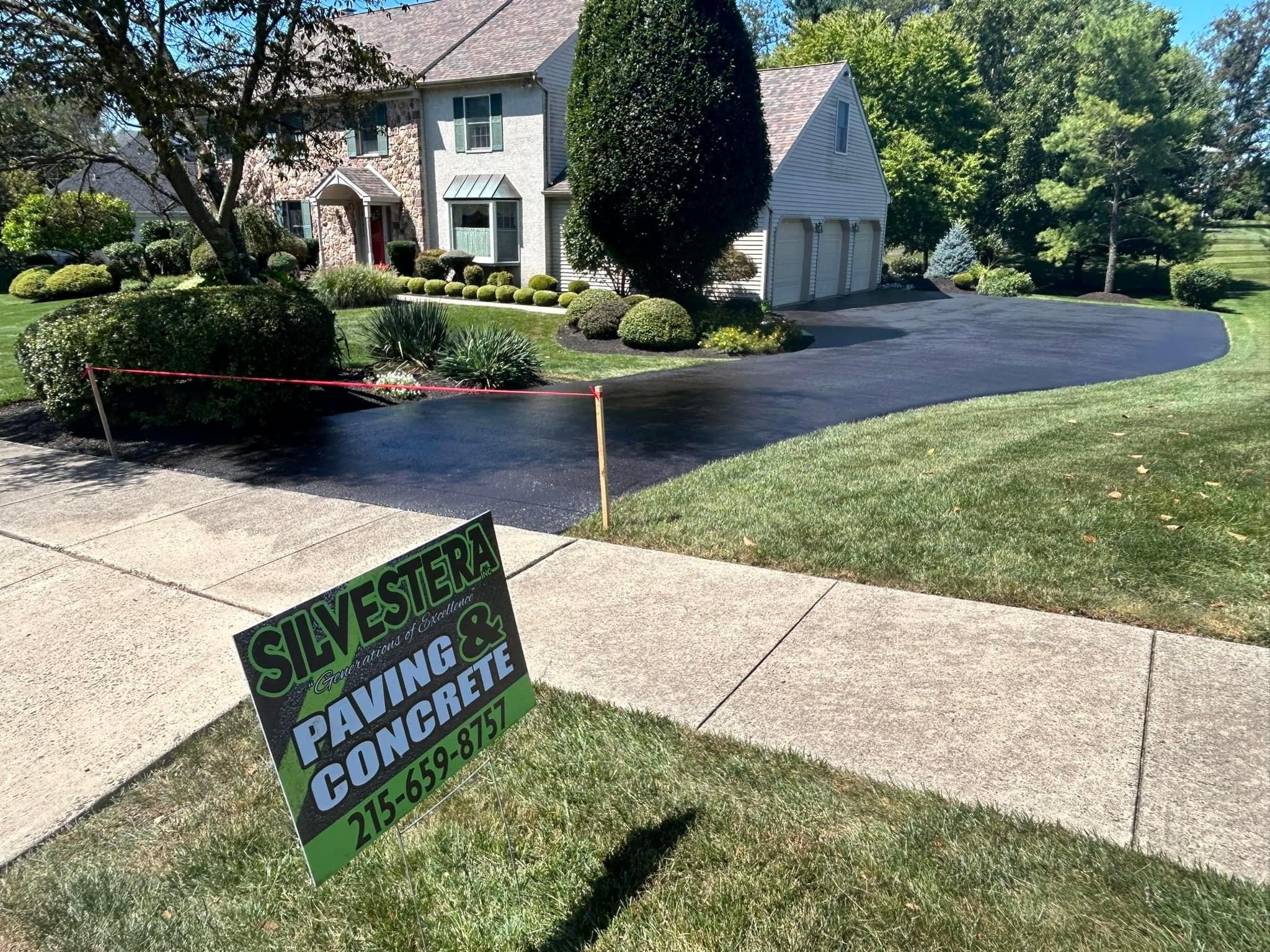 Fresh residential asphalt driveway paving project