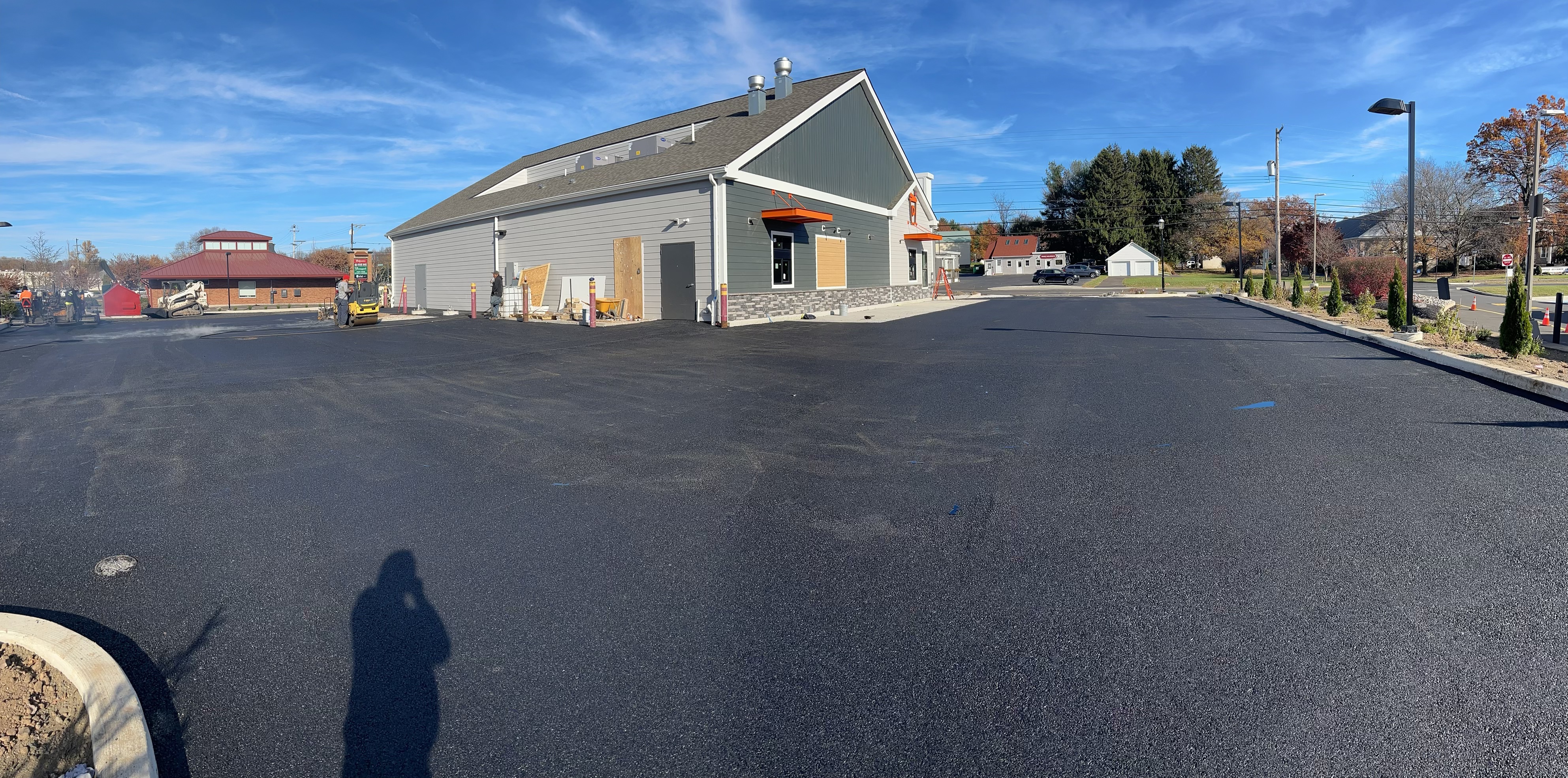 Roller compacting fresh commercial asphalt surface