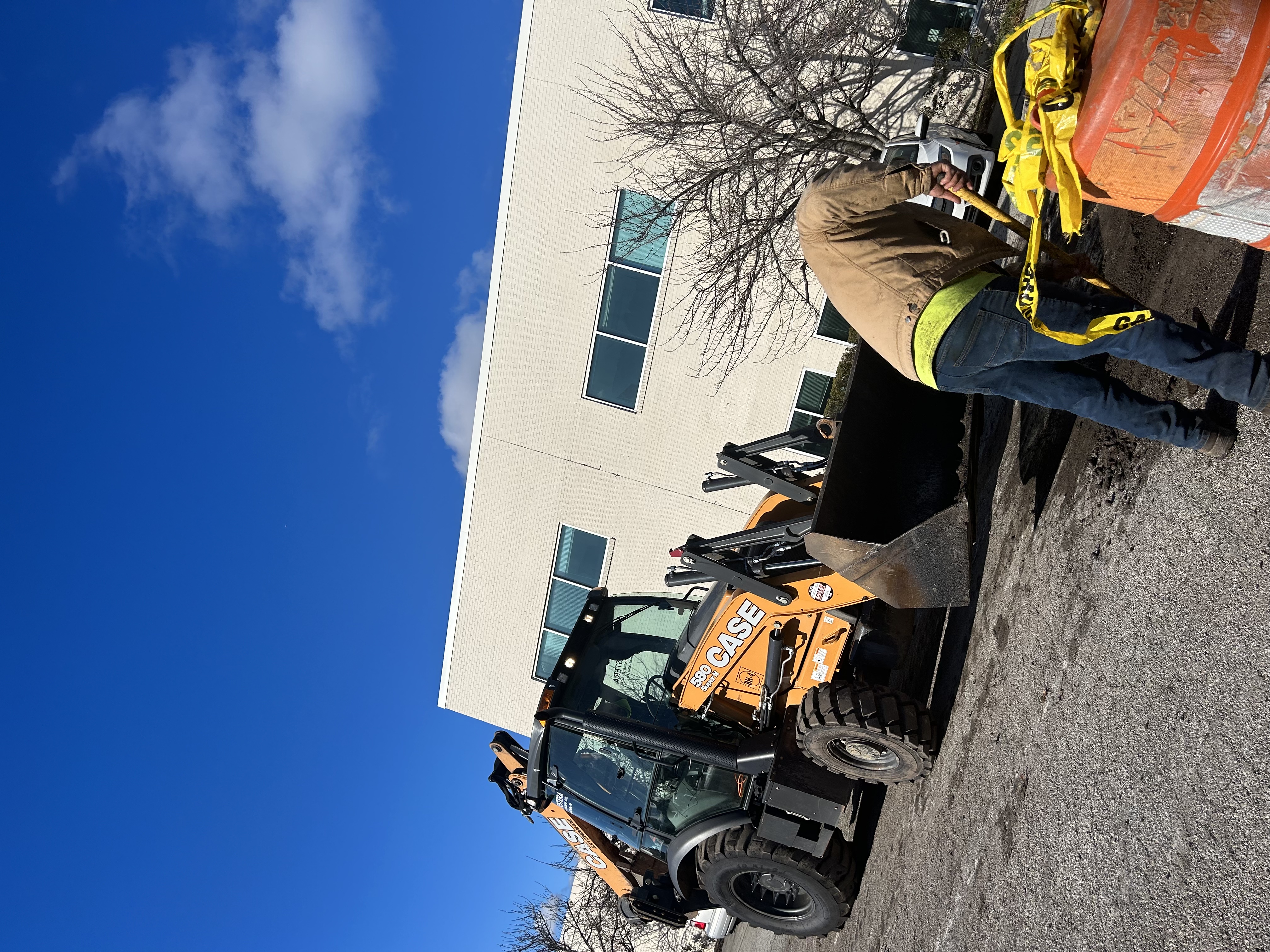 Commercial asphalt crew working on municipal roadway