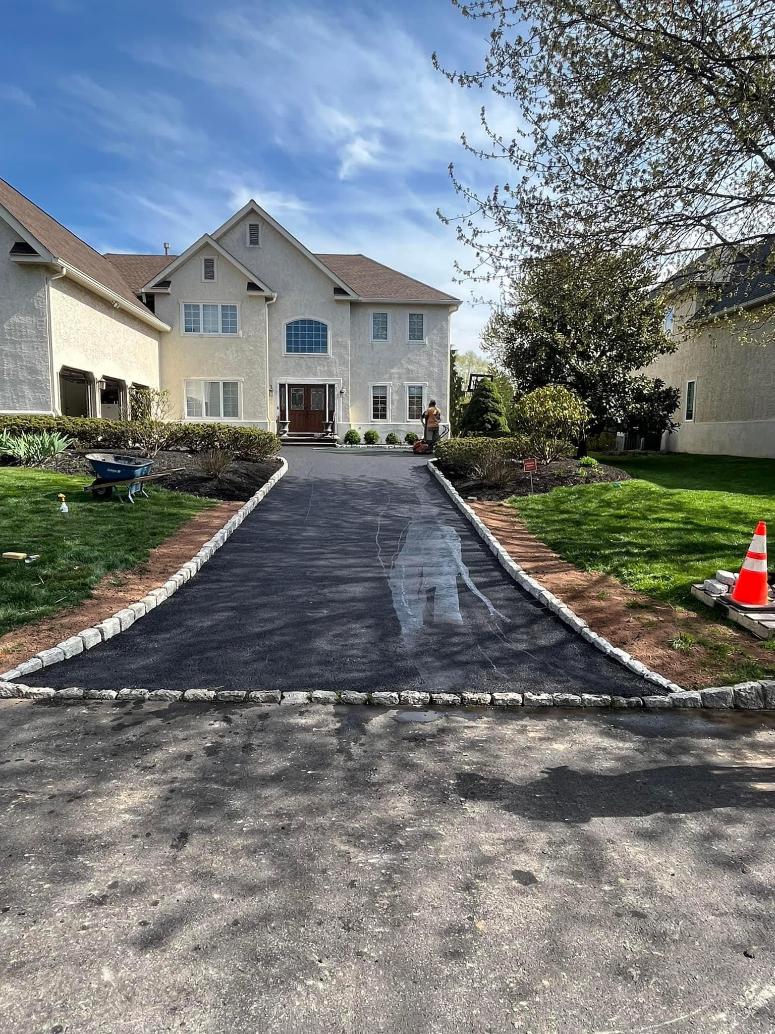 Freshly sealcoated residential driveway showing deep black uniform surface that protects the asphalt investment for years
