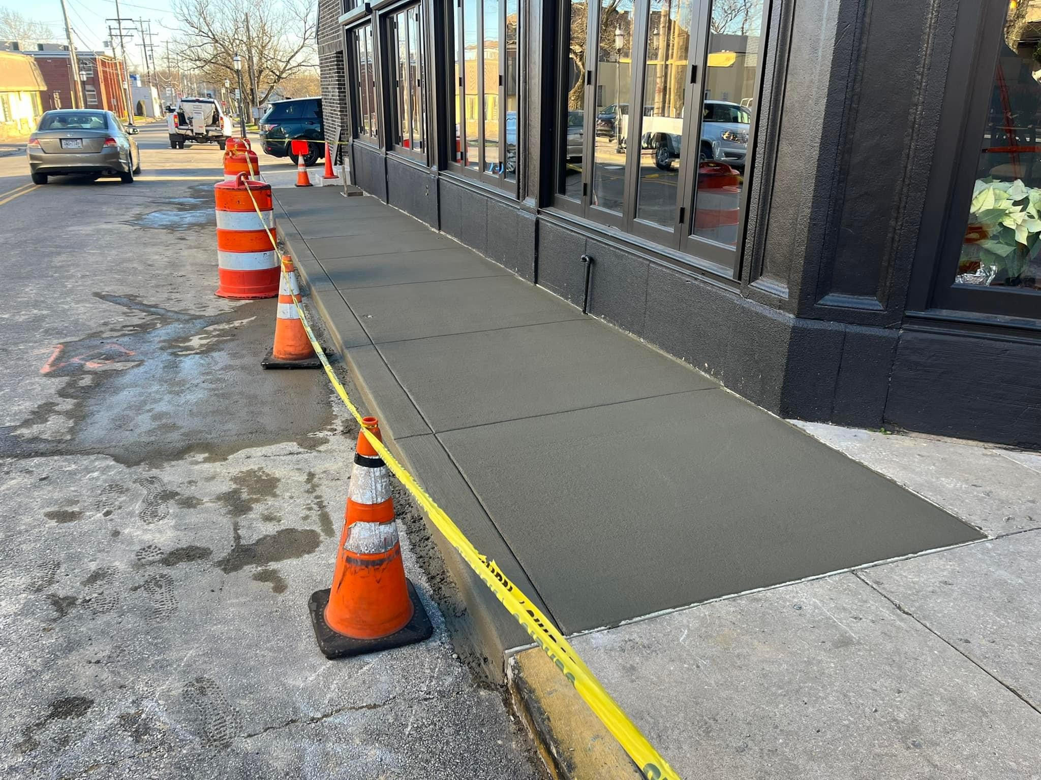 Completed concrete sidewalk and approach paving