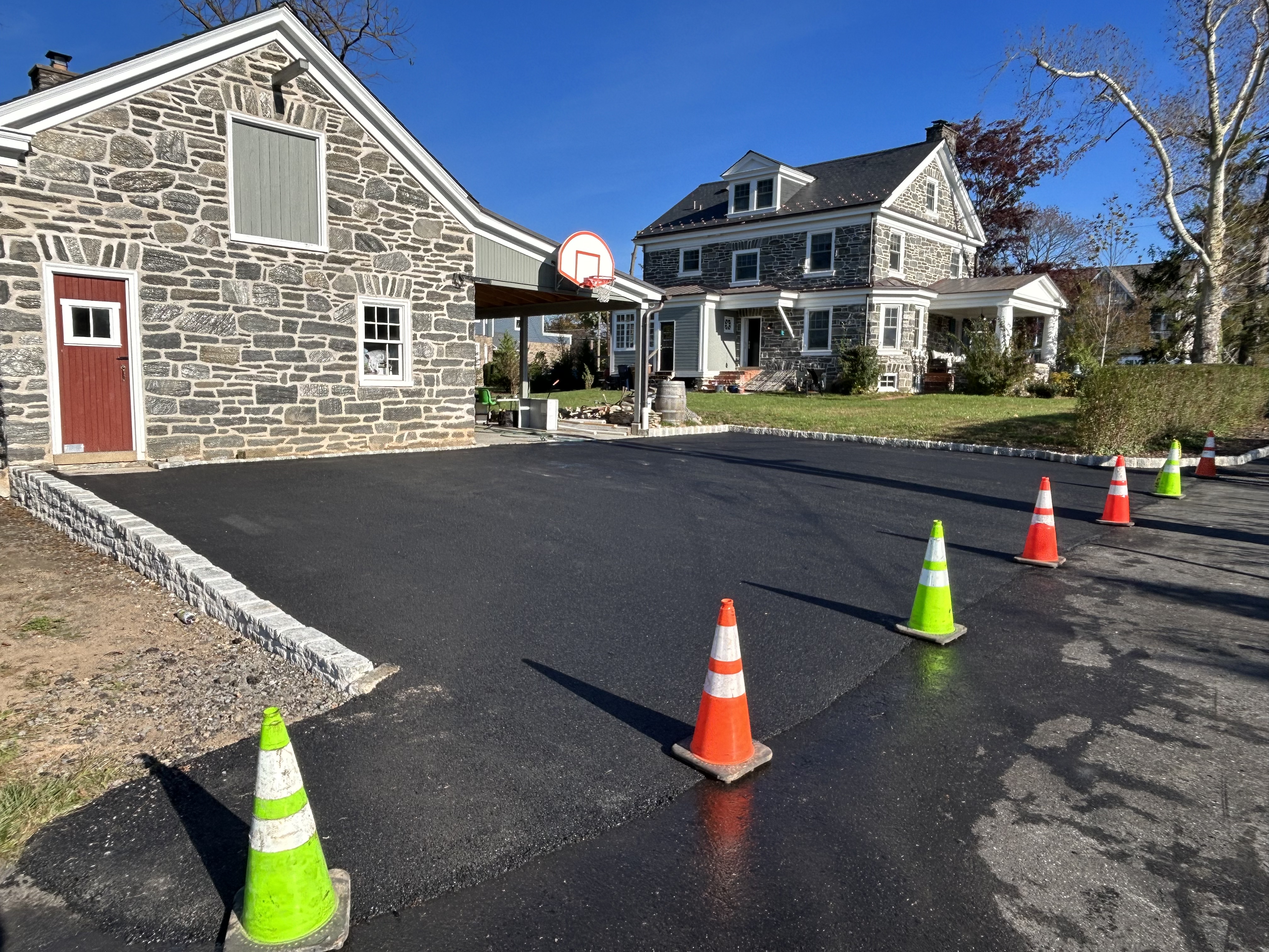 Residential driveway paving completed with roller compaction