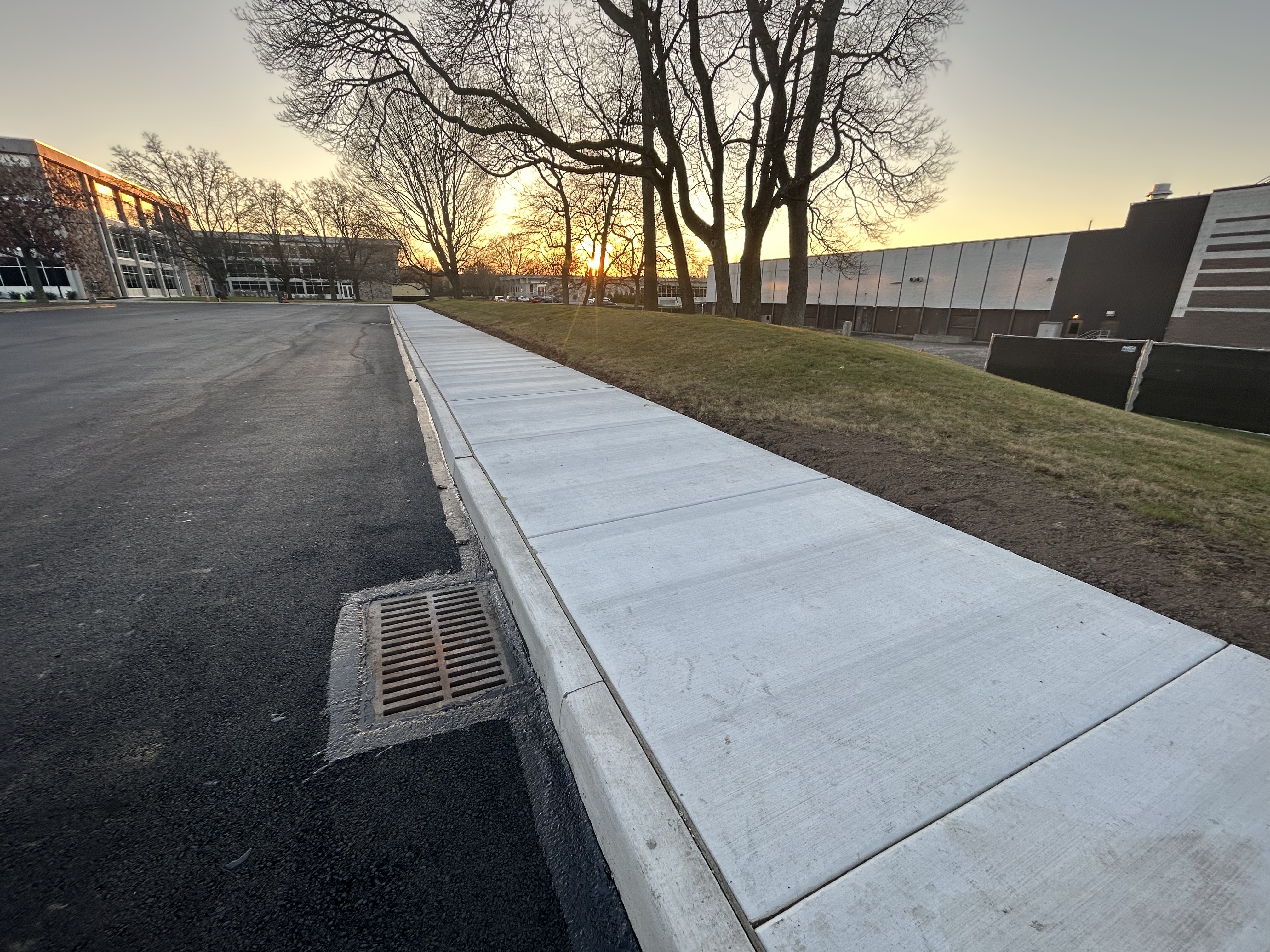 Commercial paver machine distributing asphalt on roadway