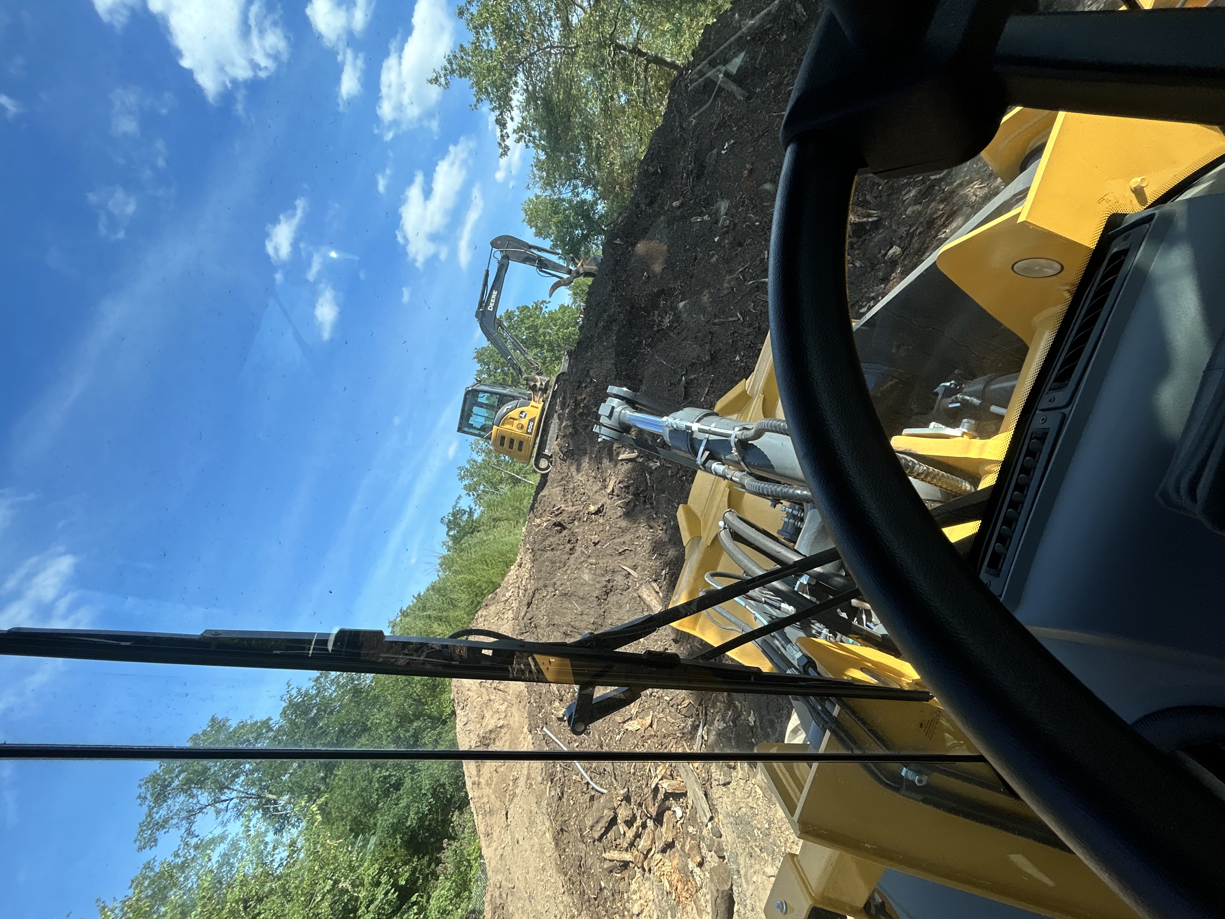 Site grading and leveling operations with earthmoving equipment