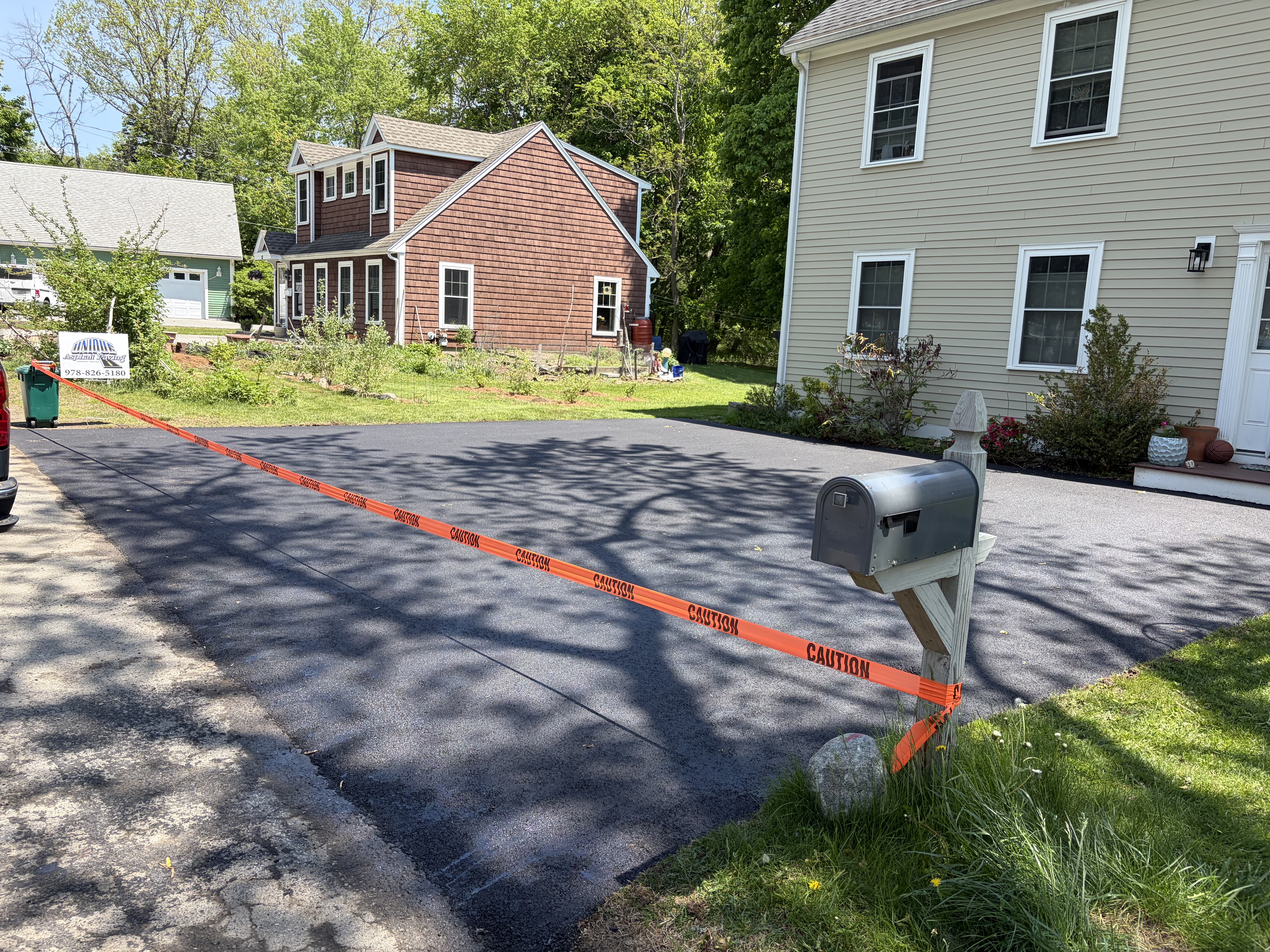 Finished residential paving project with smooth blacktop in Andover, MA