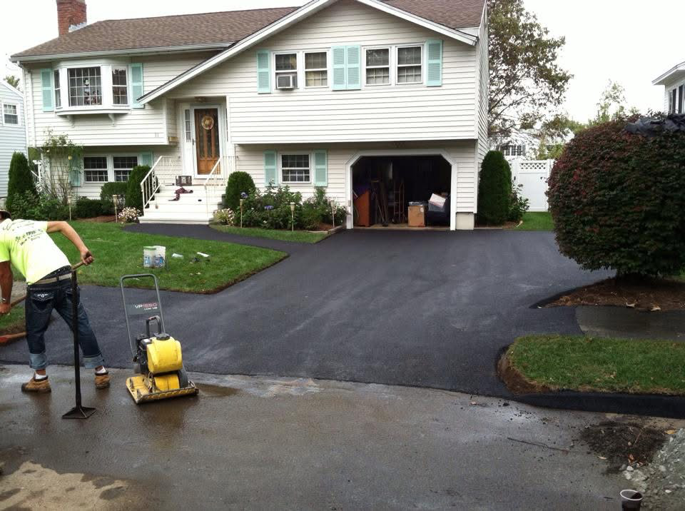 Completed residential asphalt driveway with smooth black finish in Lawrence, MA