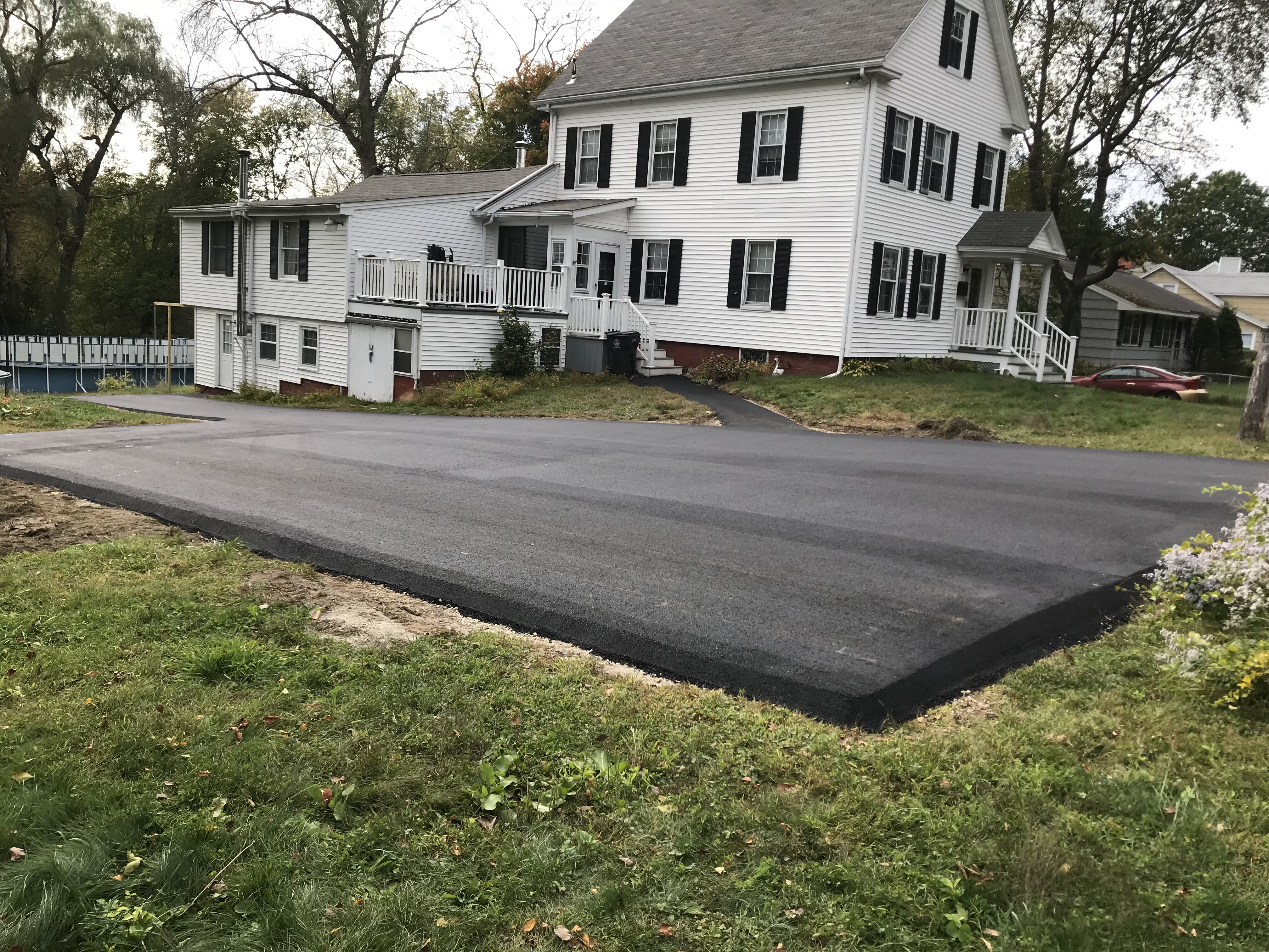 After: Fresh smooth asphalt driveway in Merrimac, MA — completed by Unique Asphalt Paving