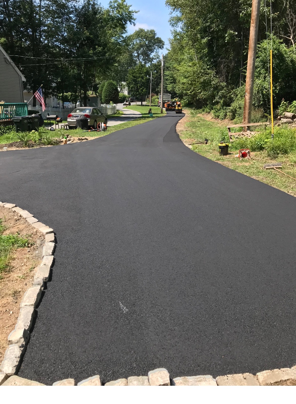 Completed roadway paving project with smooth black asphalt surface in North Andover, MA
