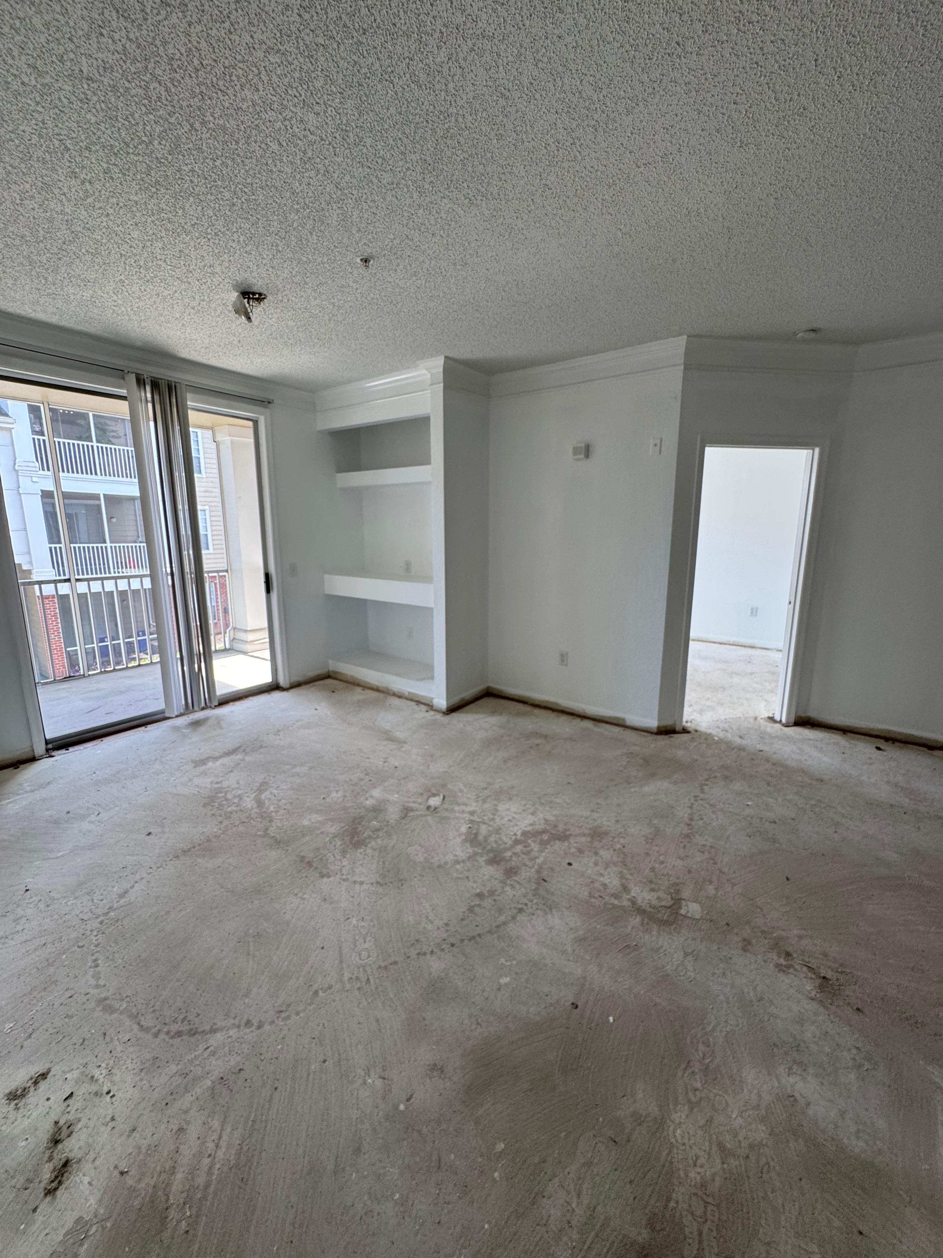 Before renovation — concrete subfloor and unfinished space