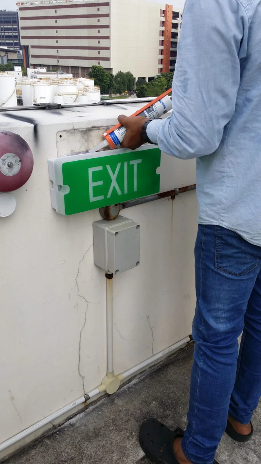 Ezzogenics technician installing exit sign Ezzogenics technician installing exit sign