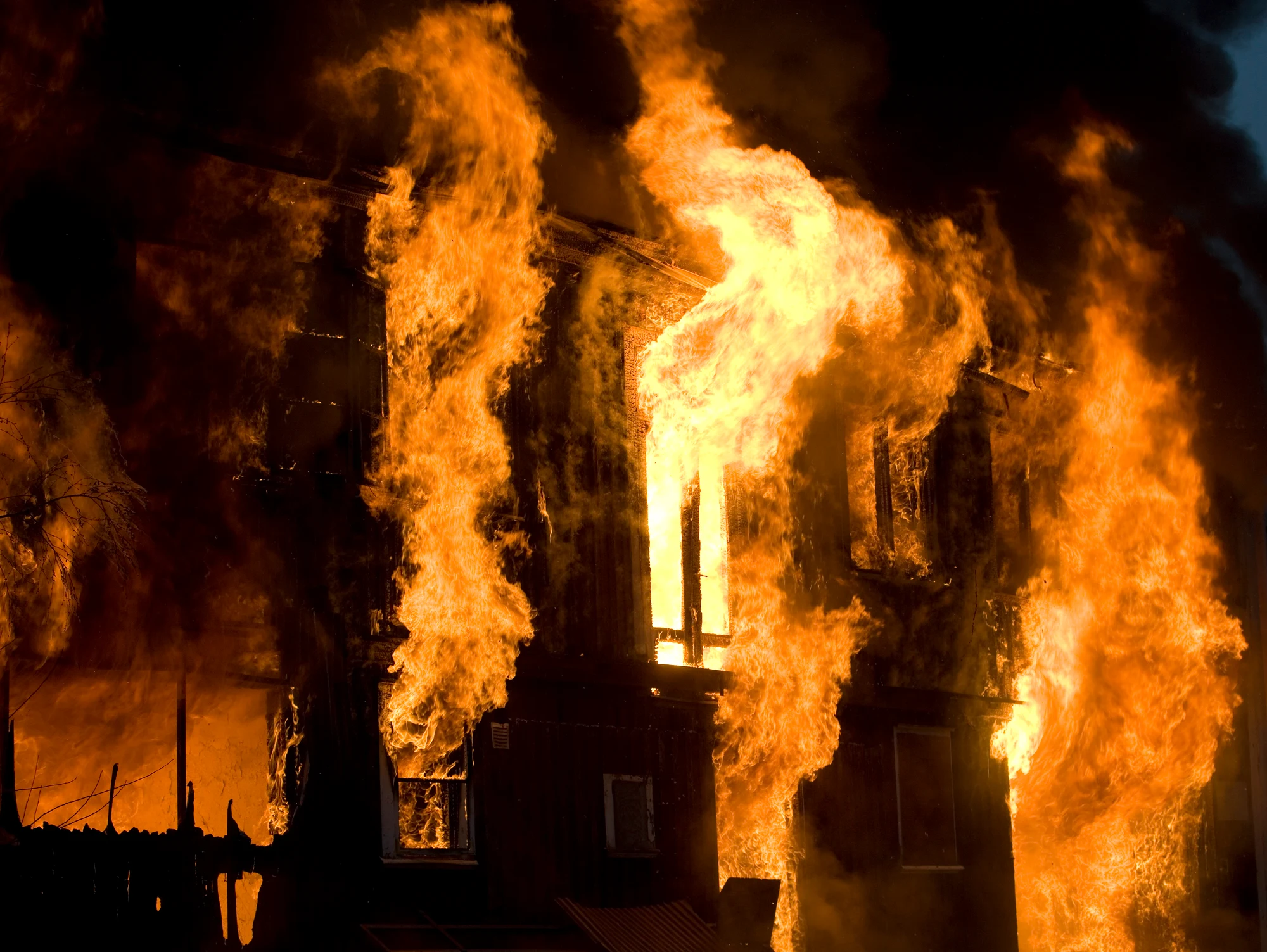 Real fire emergency demonstrating the critical need for professional fire safety systems Building fire emergency scene showing intense flames and smoke