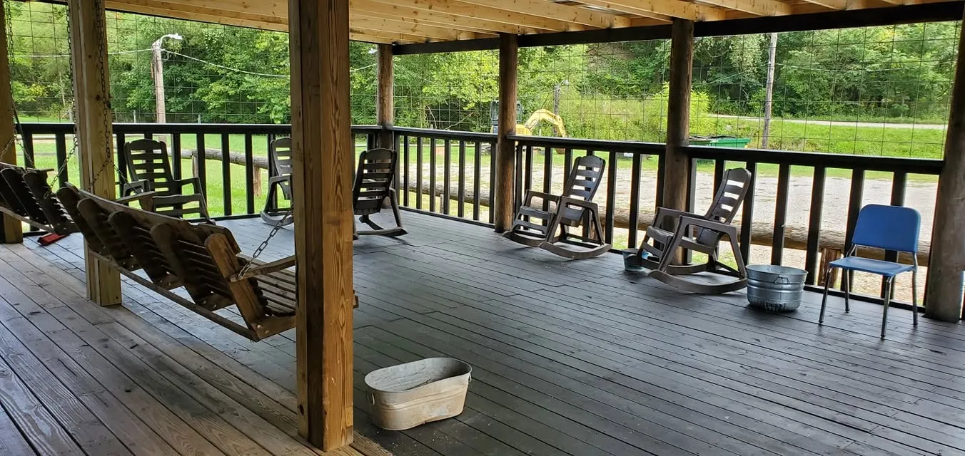 The Farm Bar & Grill covered porch with rocking chairs and swing