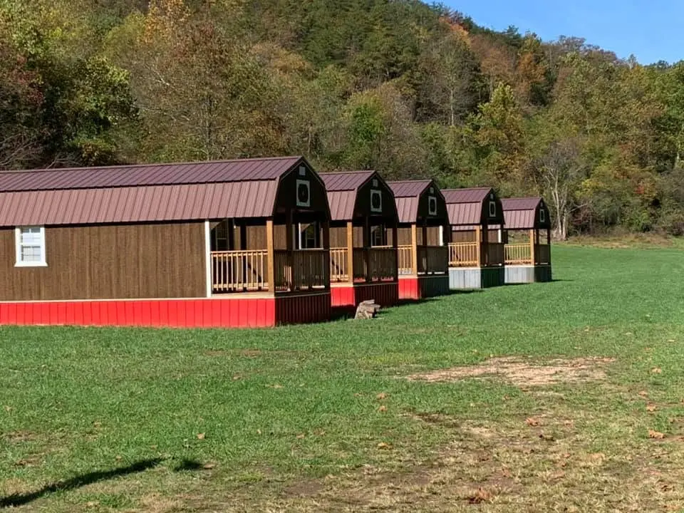 Row of cozy cabin rentals at The Farm Bar & Grill with mountain views